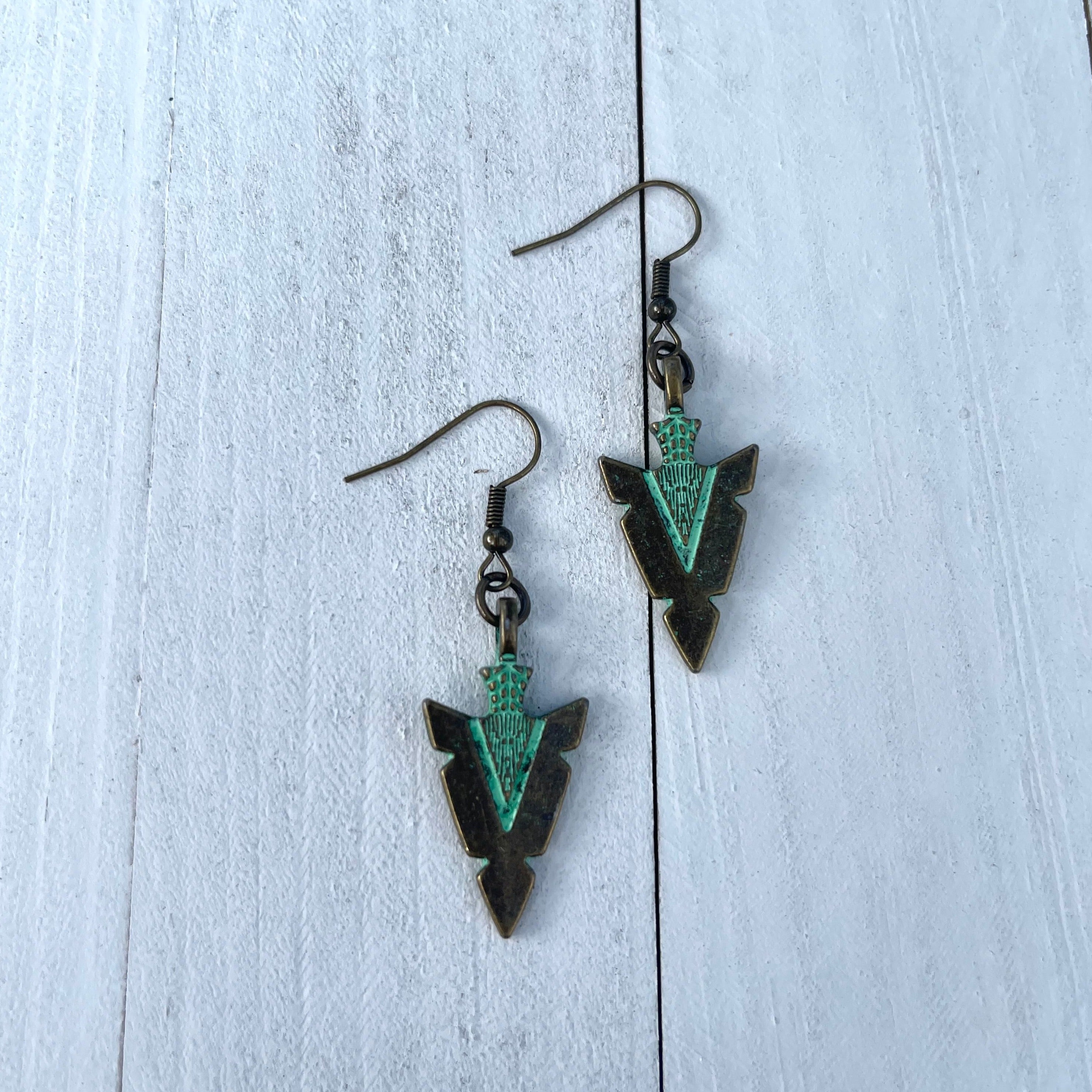 Handcrafted earrings on brass earring wires. Bronze colored pewter arrowhead pendants. 