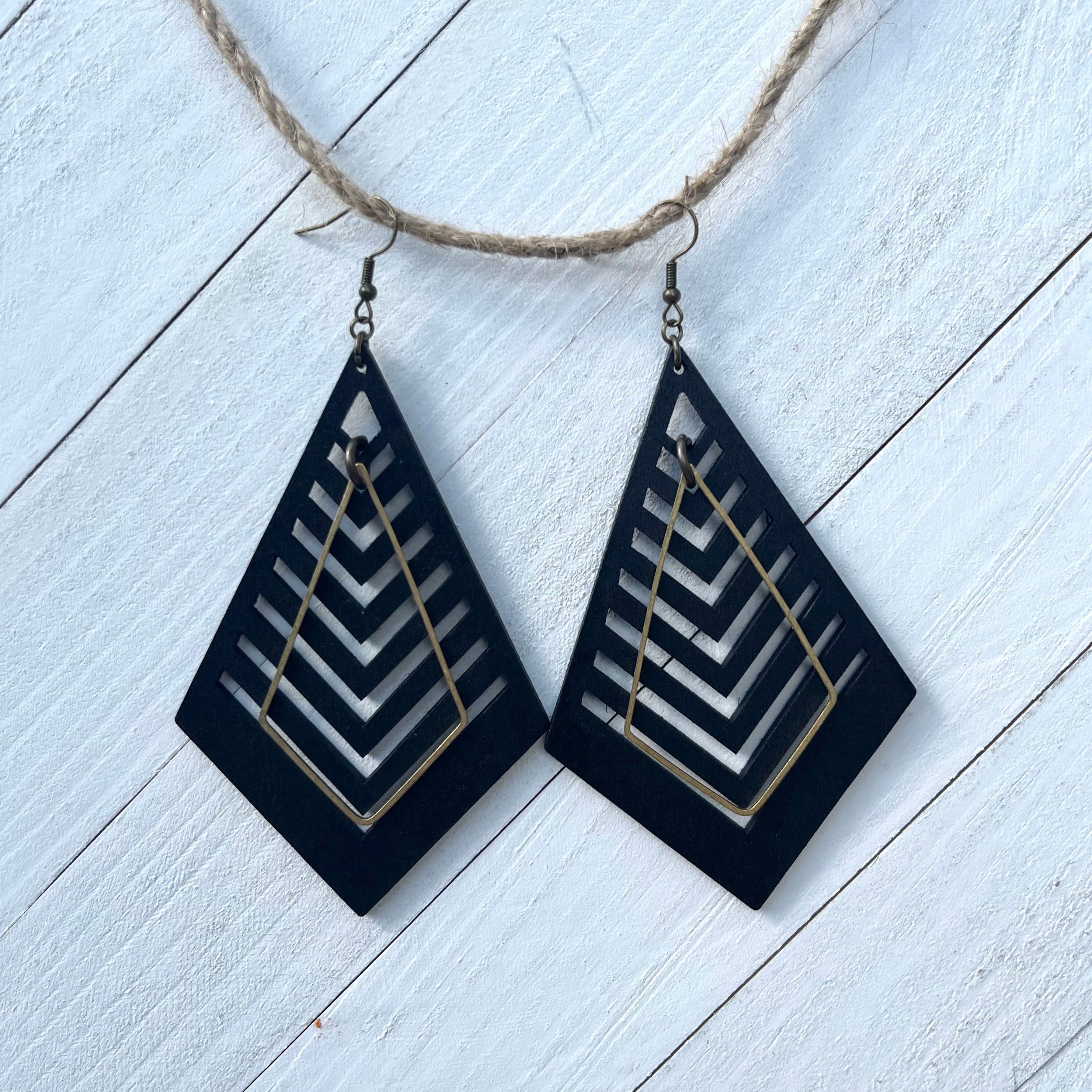 Handcrafted earrings with brass earring wires and components. Raw brass geometric kite shaped component. Aspen laser cut wood pendants. 