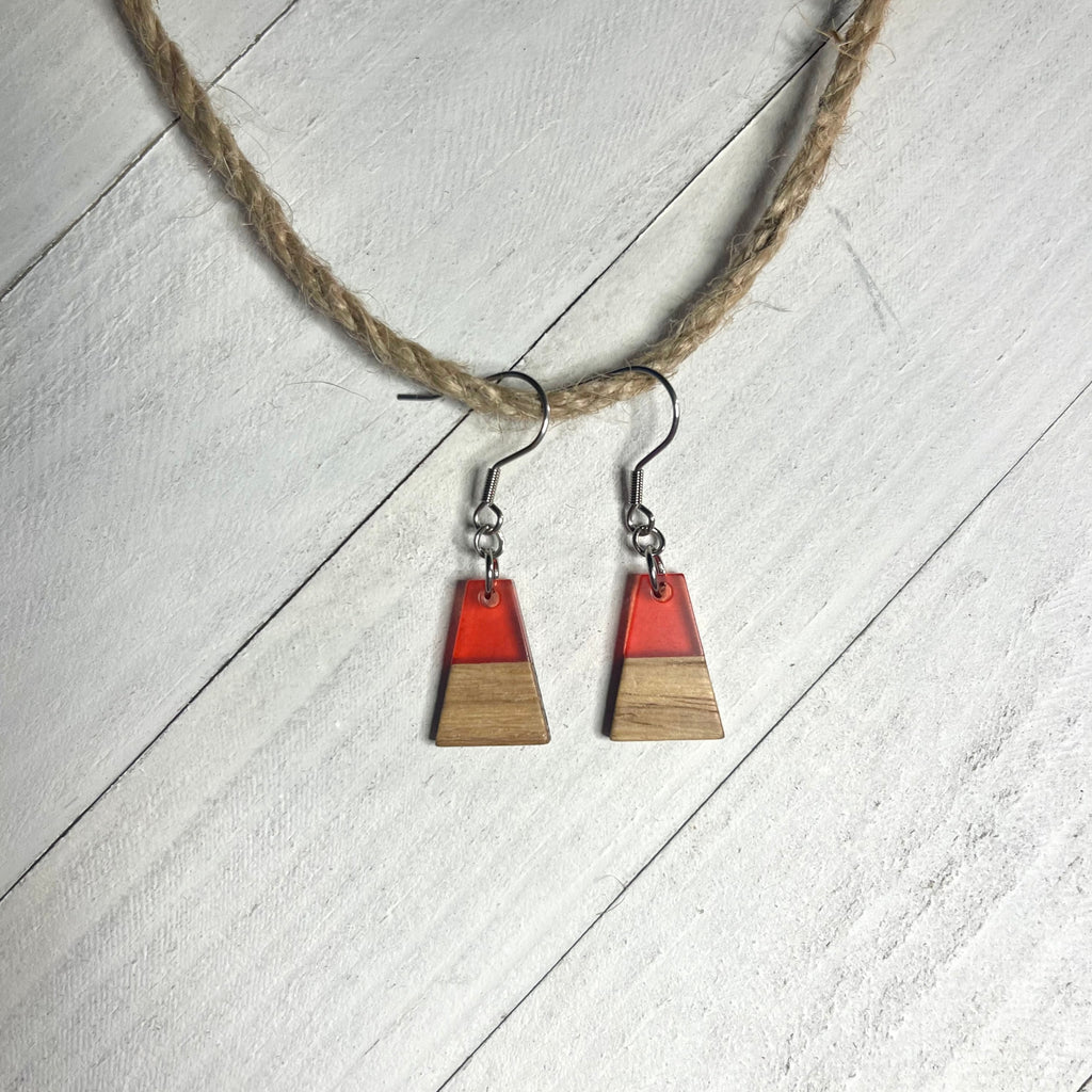 Handcrafted earrings with stainless steel earring wire and components. Clear red resin and wood charms.