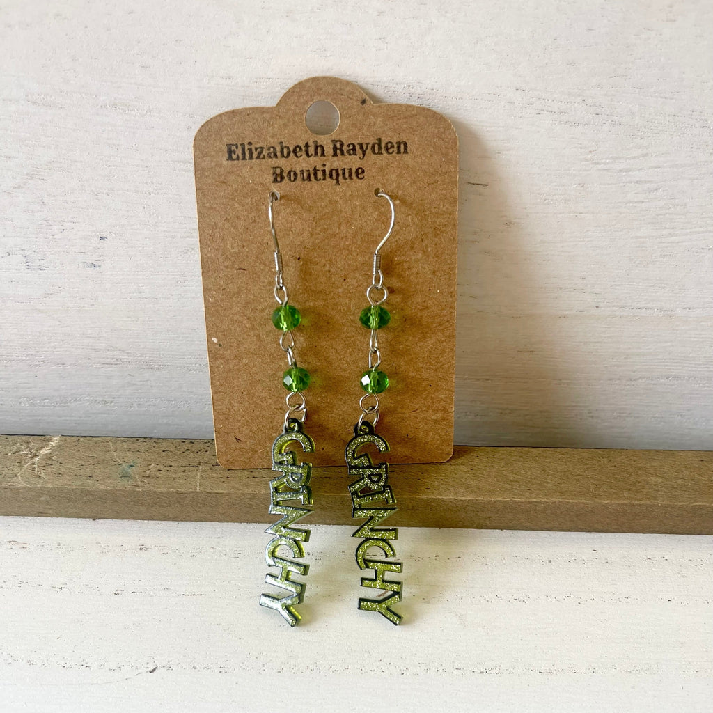 Handcrafted earrings with stainless steel earring wires.
Stainless steel components.
Glass beads.
Plastic glitter Grinch charm.