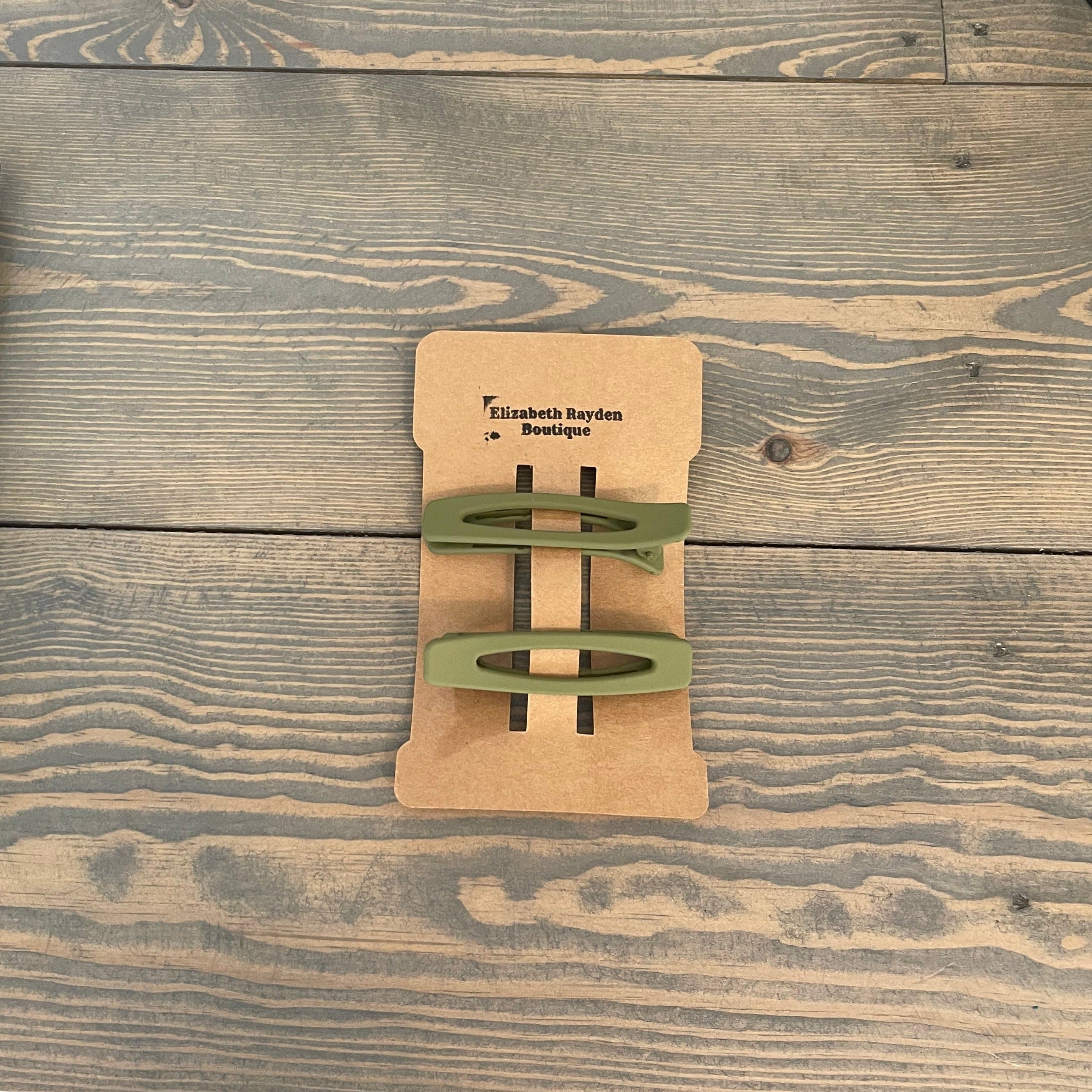 Pair of alligator hair clips. Rectangular shape with oval opening. Matte finish. Length: 5/8" Width: 2 5/8"