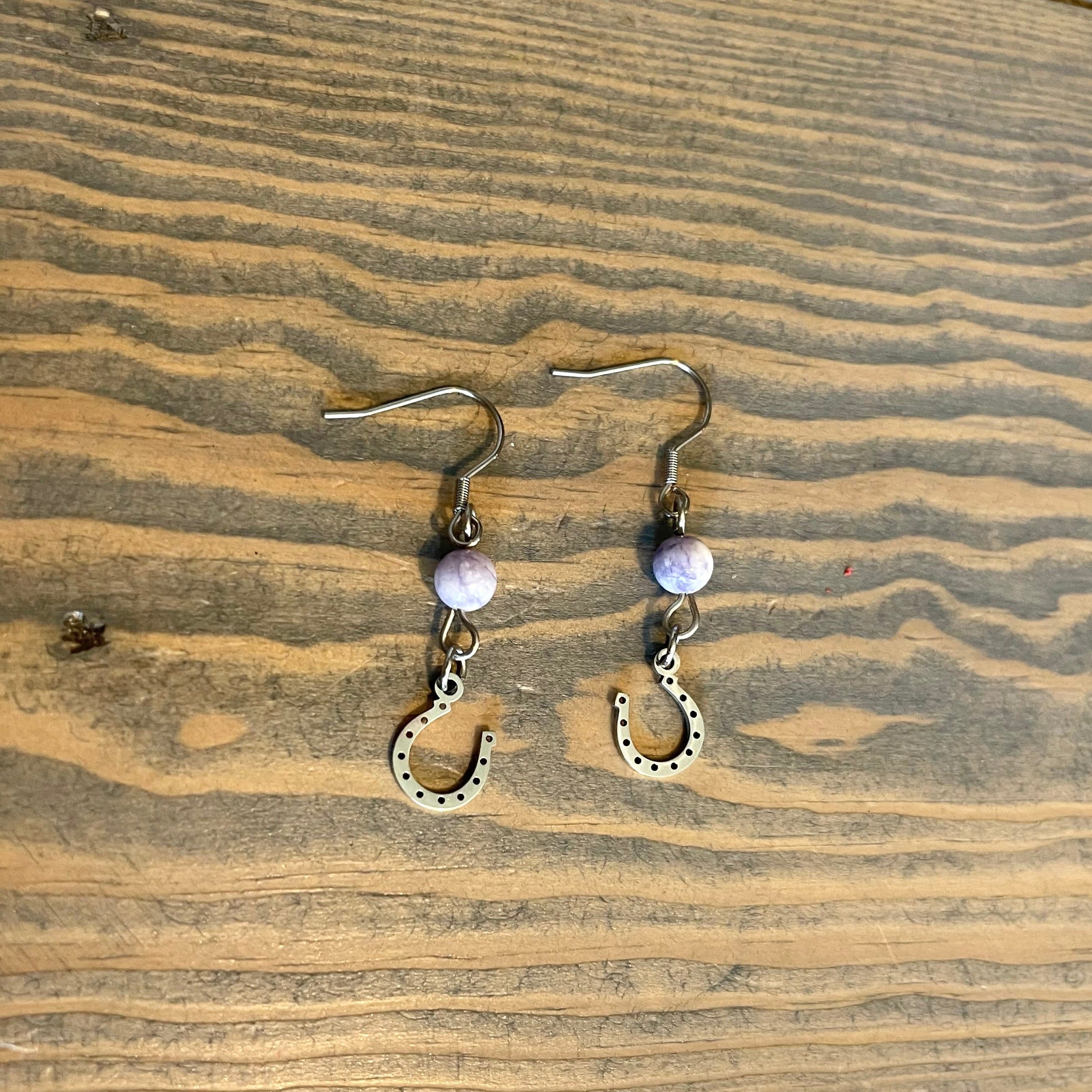 Handcrafted earrings with stainless steel wires and components. Stainless steel horse shoe charms. Natural purple turquoise gemtones.