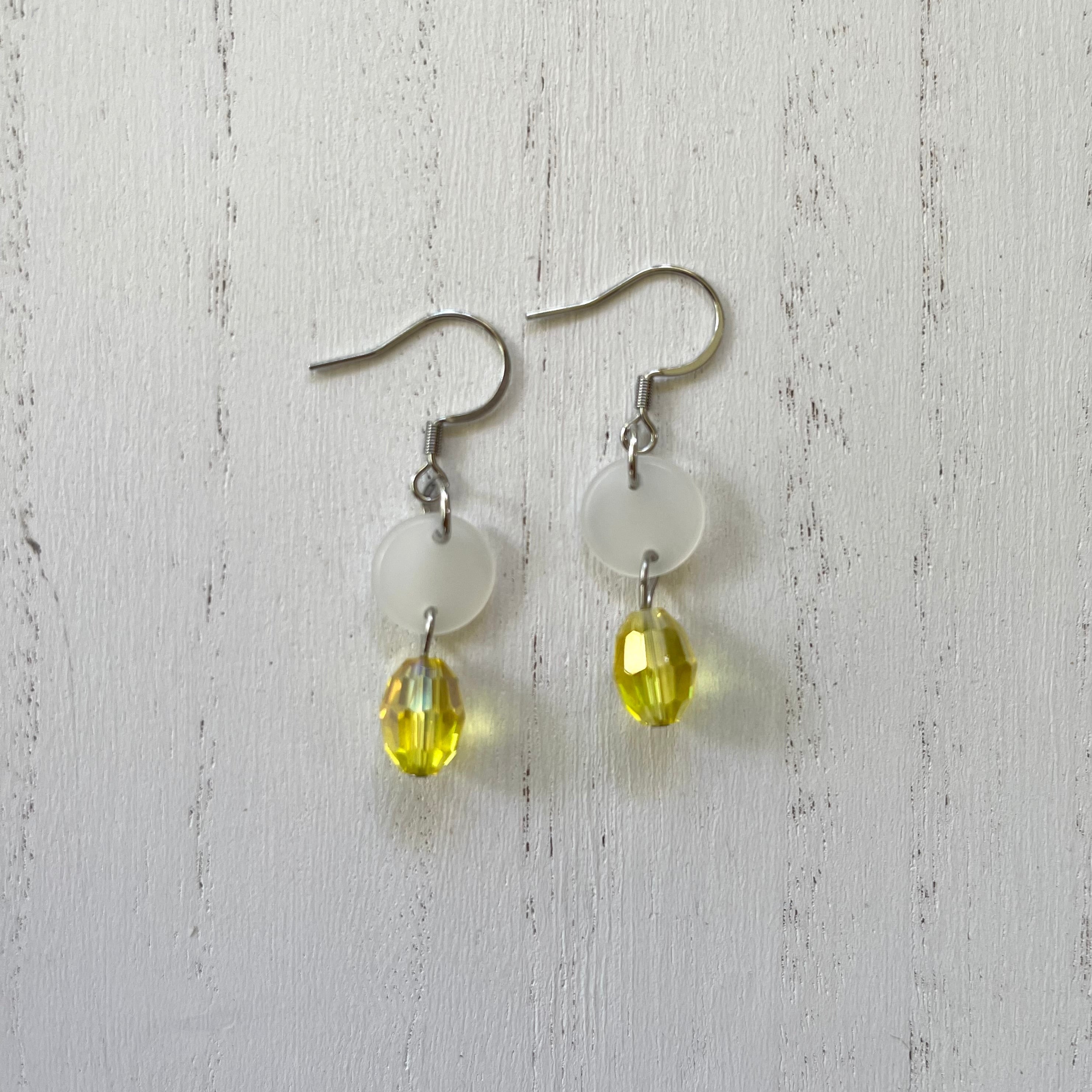 Handcrafted earrings on stainless steel earring wires. Stainless steel components. Acetate discs and glass beads. 