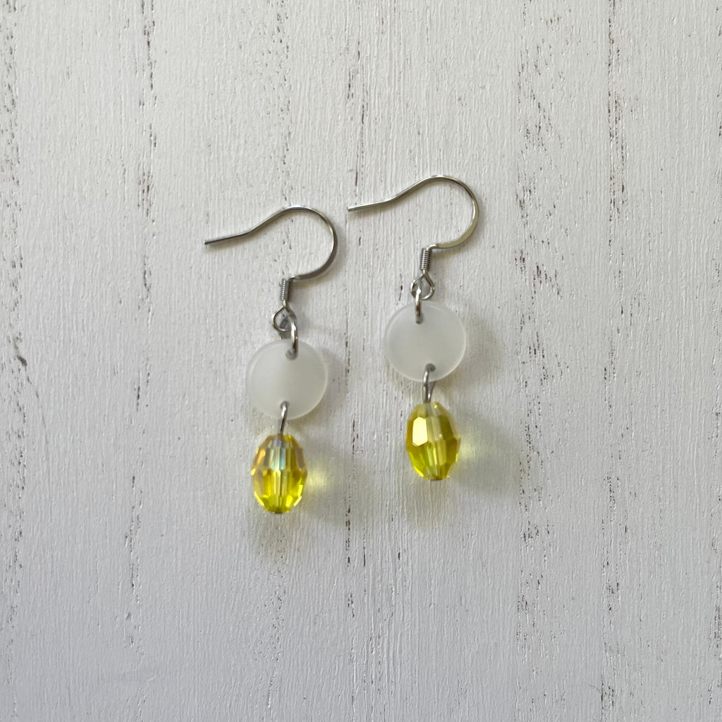 Handcrafted earrings on stainless steel earring wires. Stainless steel components. Acetate discs and glass beads. 