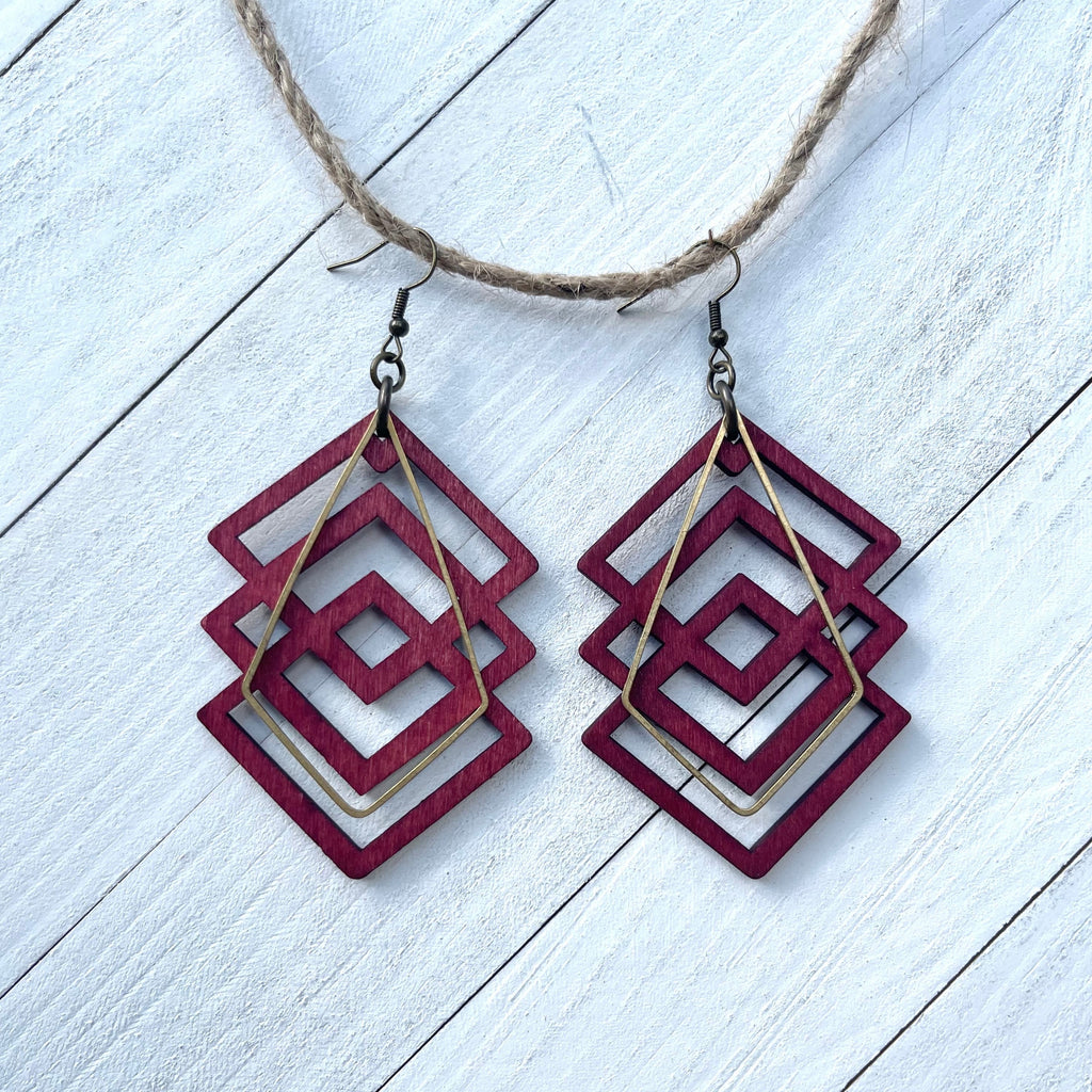 Handcrafted earrings with brass earring wires and components. Raw brass geometric kite shaped component. Aspen laser cut wood pendants. 