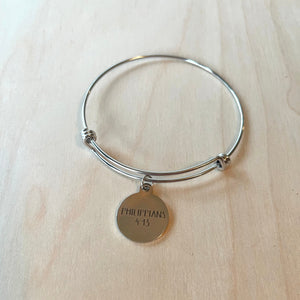 Handcrafted bangle bracelet with charm in stainless steel.  Inner Diameter: 66mm