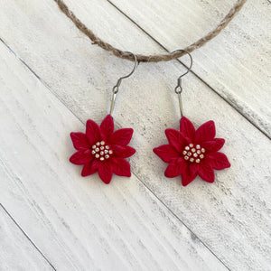 Handcrafted earrings with stainless steel wires and components.&nbsp;
Resin poinsettia pendants embellished with gold rhinestones.