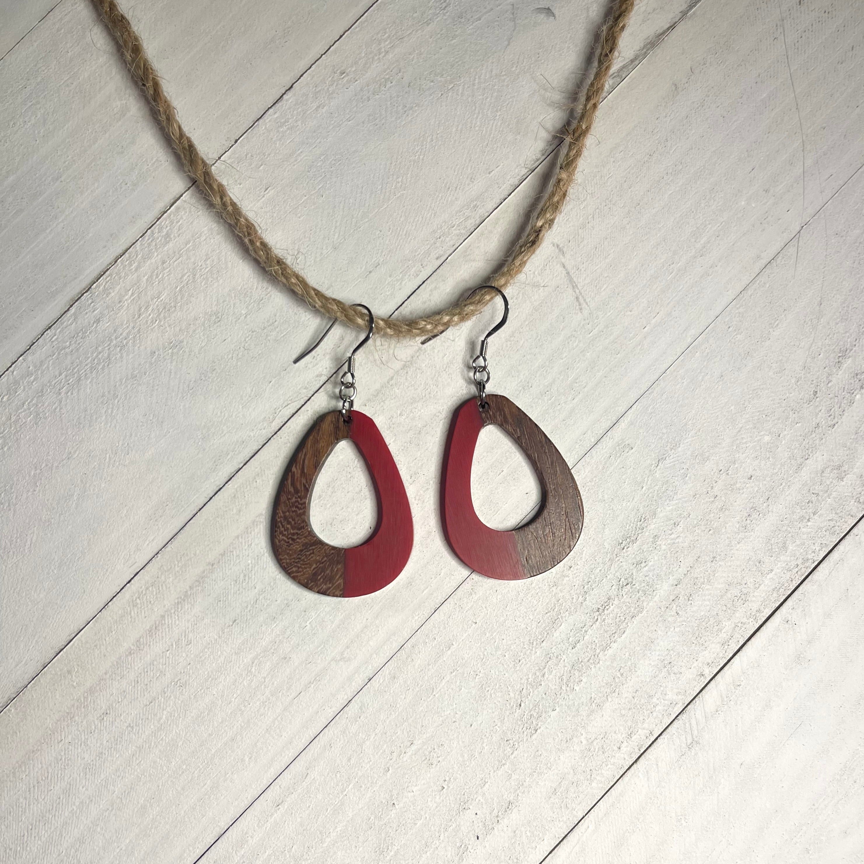 Handcrafted earrings with stainless steel earring wires and components. Red resin and wood open teardrop pendants. 