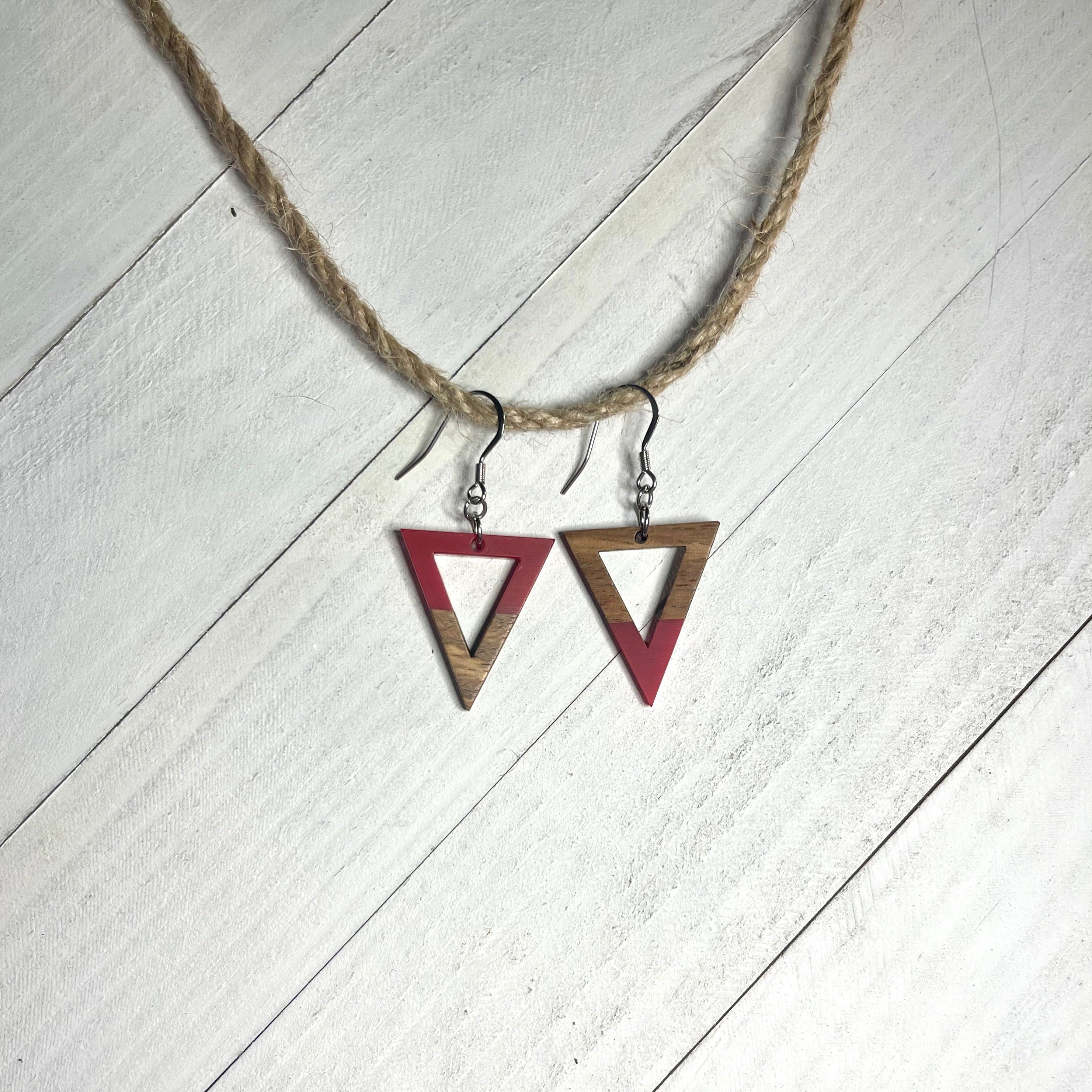 Handcrafted earrings with stainless steel earring wire and components. Red resin and wood triangle charms.