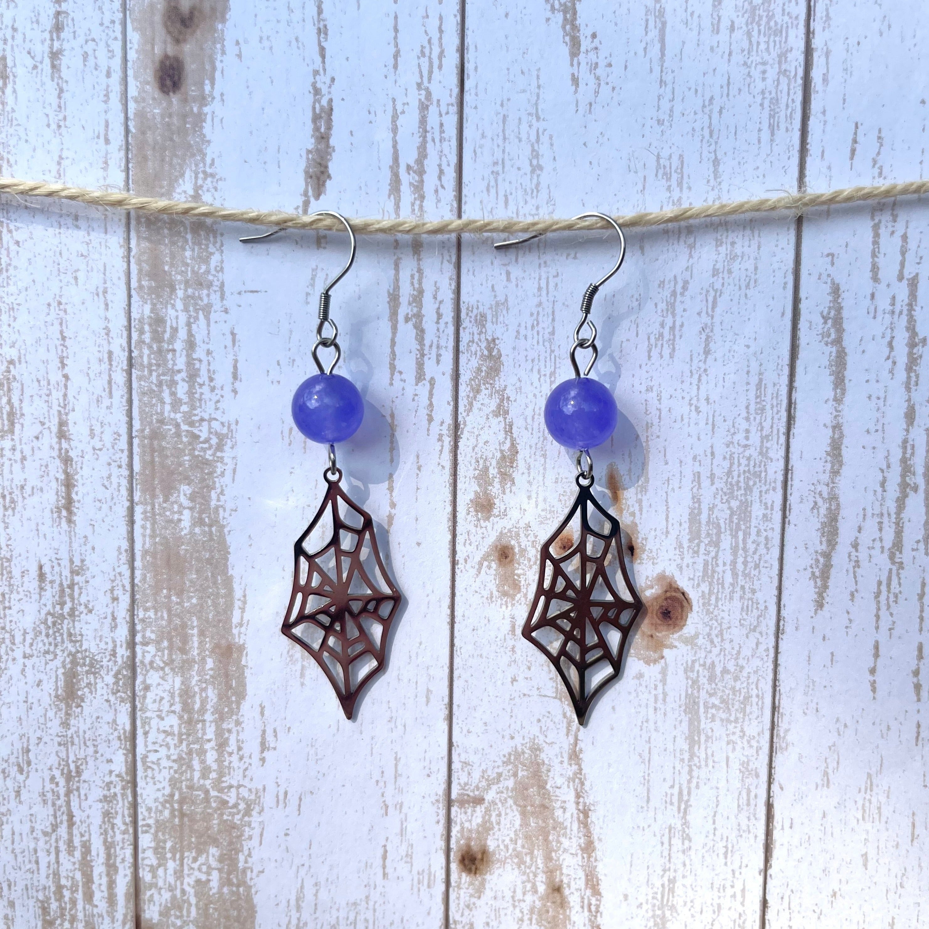 Handcrafted earrings with stainless steel earring wired and components. Stainless steel charms. Purple quarzite.