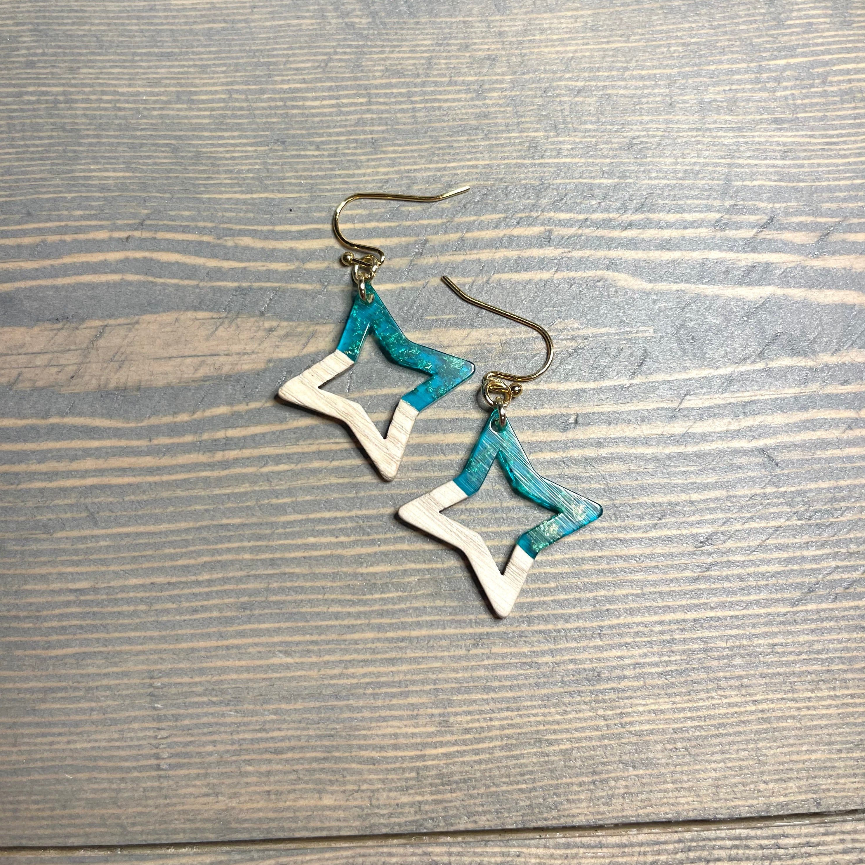 Handcrafted earrings with stainless steel earring wires and components. Wood and resin with gold flakes star charms. 