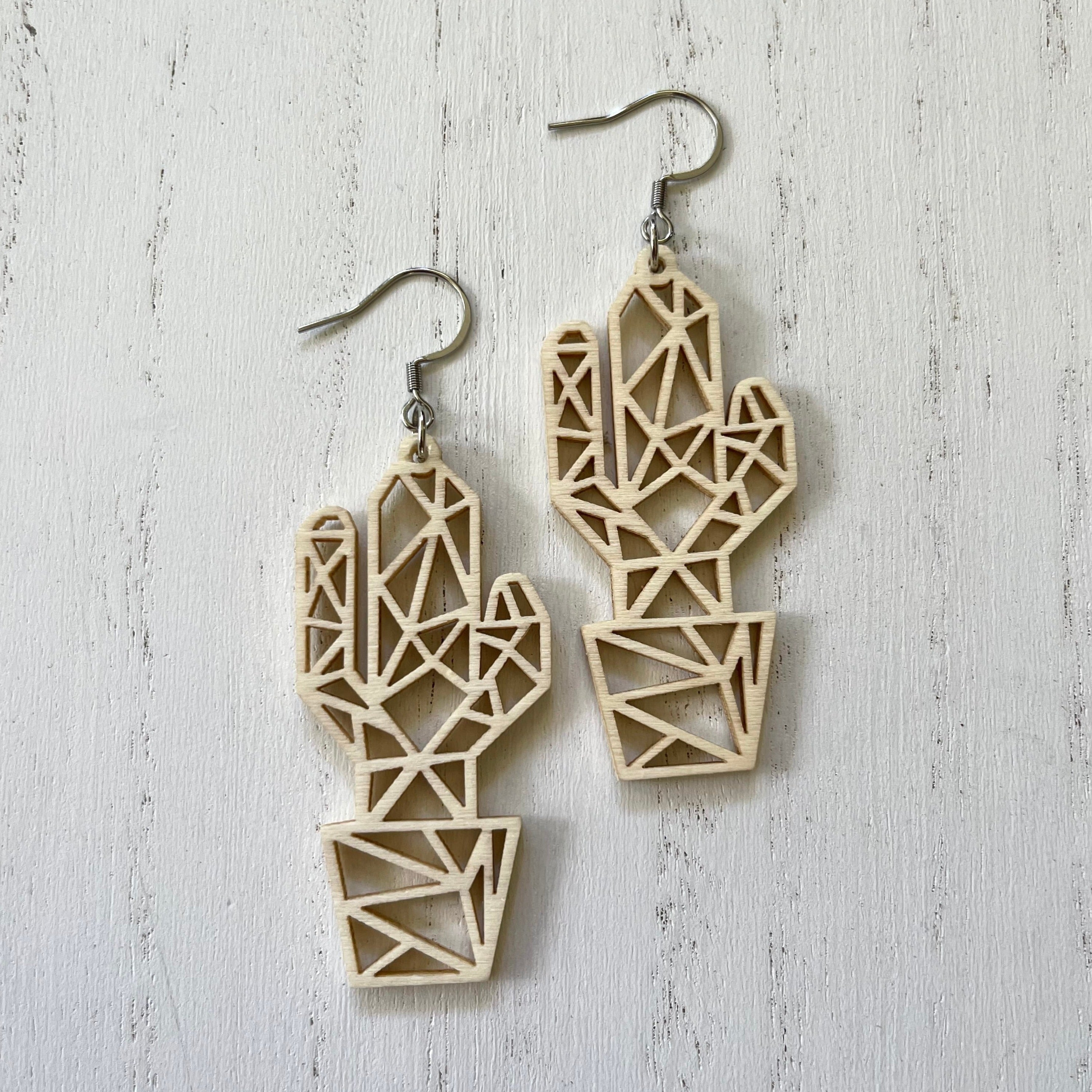 Handcrafted earrings with stainless steel wires and components. Filigree wood construction cut out design.