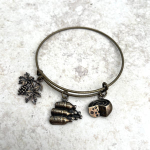 Handcrafted antique brass bangle bracelet with antique brass wine charms. Diameter 2.5 inches. One size fits most.