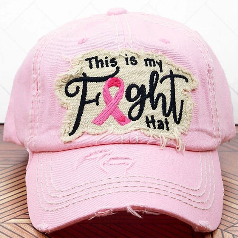 Pink distressed hat with a patch. Also has a pink ribbon stitched on the back of the hat.  100% cotton. Velcro closure.  Adjustable. One size fits most.