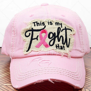 Pink distressed hat with a patch. Also has a pink ribbon stitched on the back of the hat.  100% cotton. Velcro closure.  Adjustable. One size fits most.