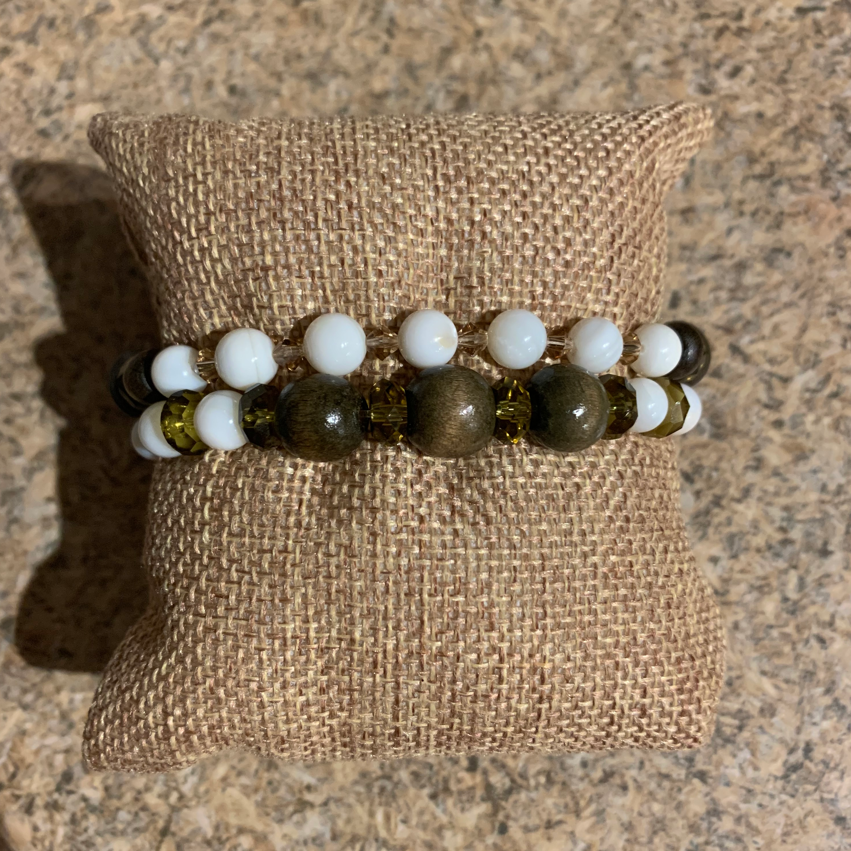 Handcrafted on professional Ninja Stretch Cord. Beaded with wood beads, river shell beads, and glass faceted rondelle and bicone beads. 