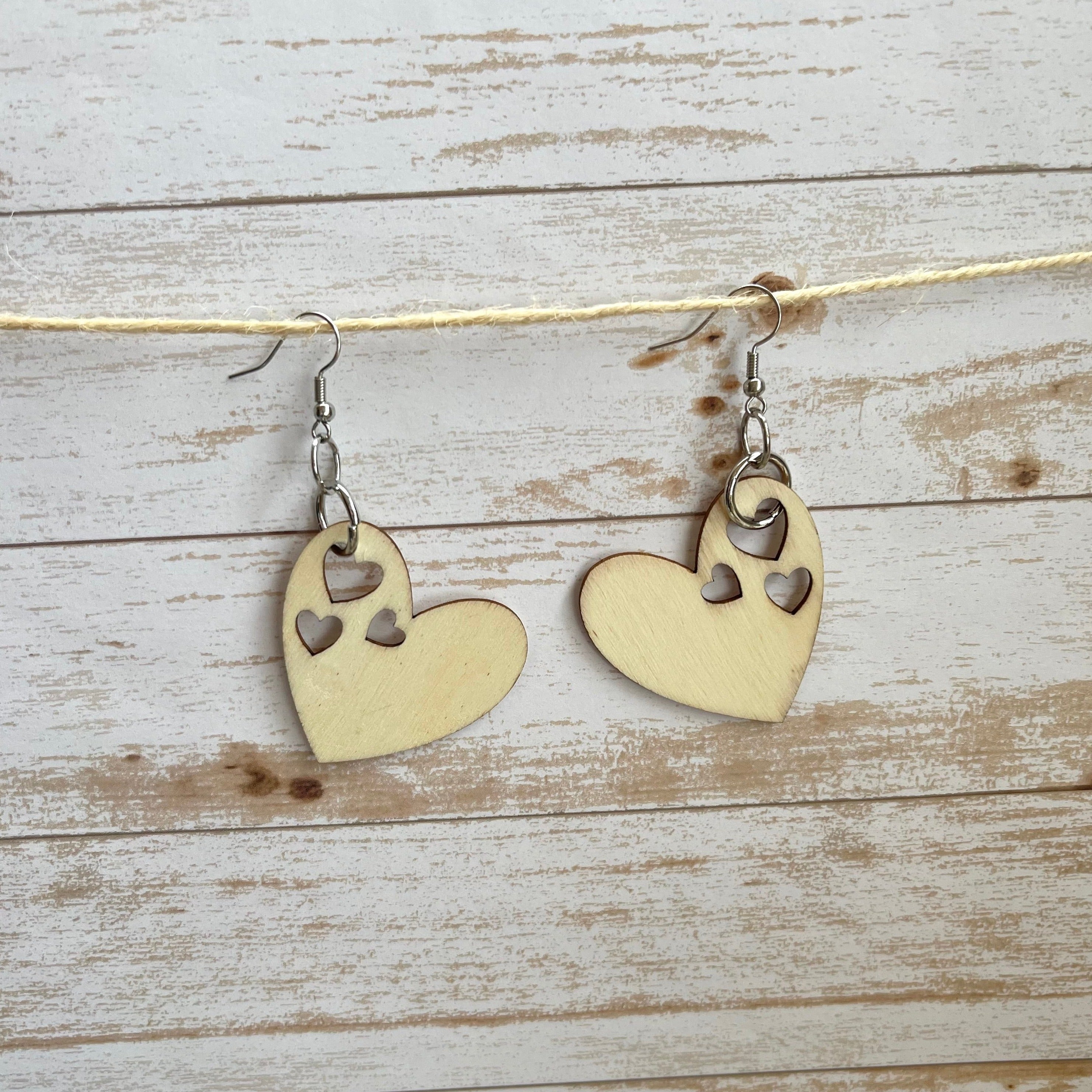 Wooden heart cutouts.  Silver plated earring wires. 