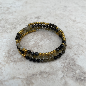 Handcrafted wrap bracelet on stainless steel memory wire. Gold sheen obsidian, gold hematite, and gold labradorite gemstones. 