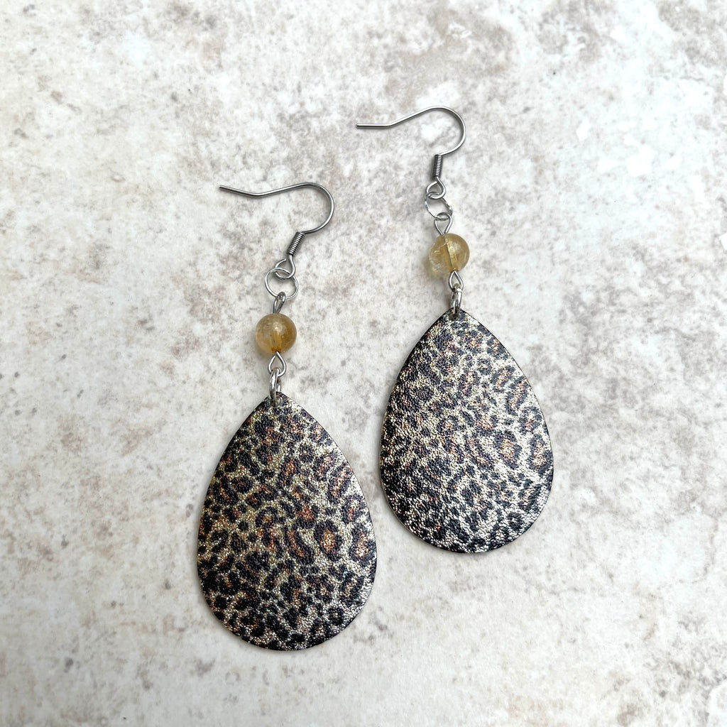 Handcrafted earrings with stainless steel earring wires. Silver metal leopard teardrop pendants. Citrine gemstones.