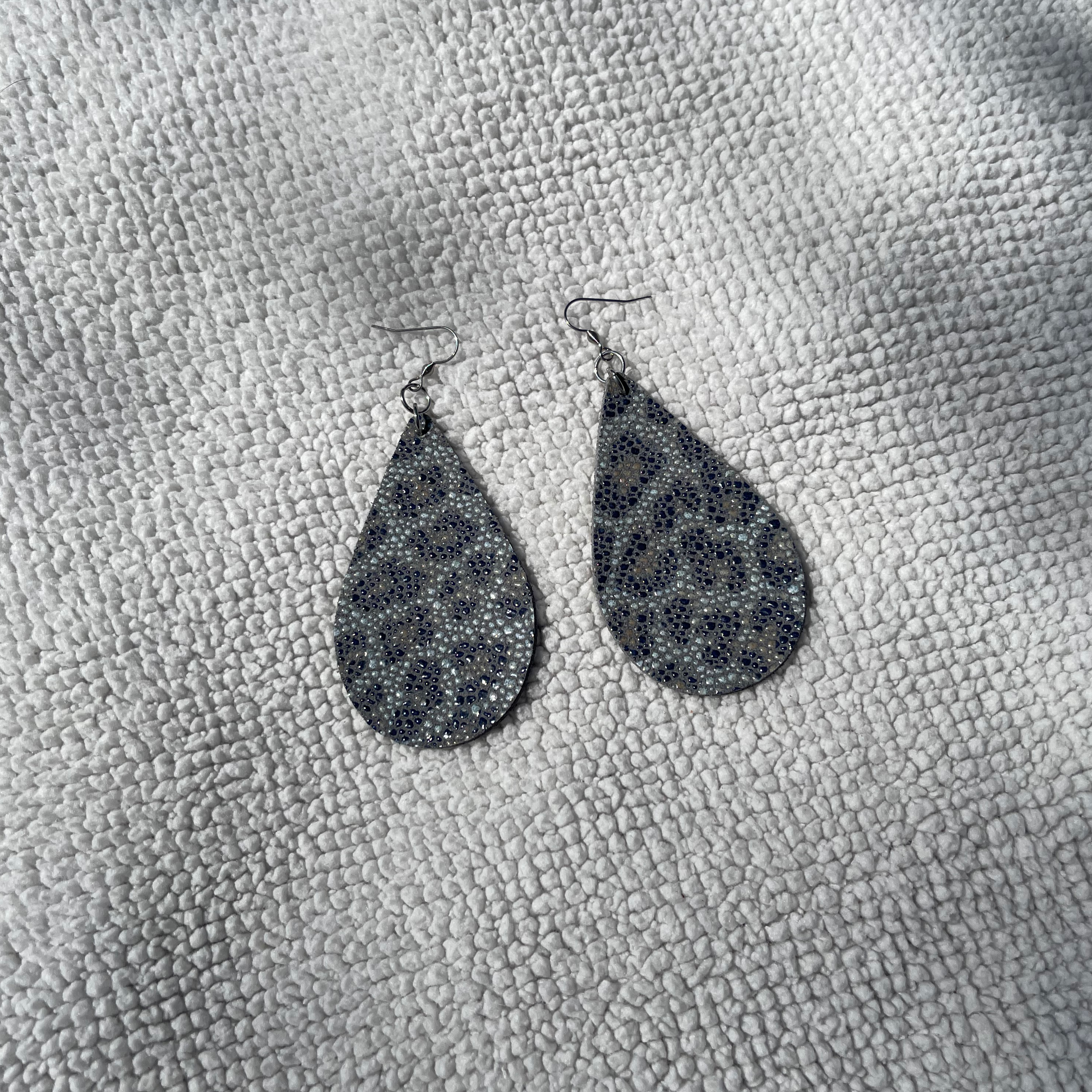 Handcrafted with all stainless steel metal. Stingray leather cut in large tear drops (3" x 1 3/4").