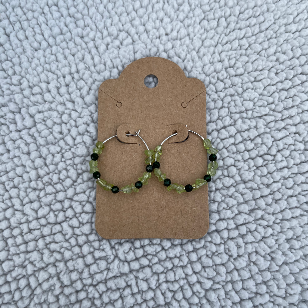 Handcrafted on 24mm silver plated hoops. Peridot chips and 3mm faceted green goldstone beads.