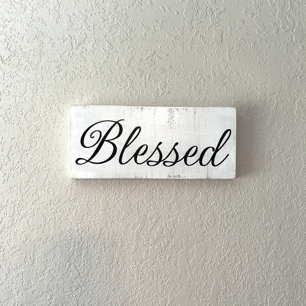 Handcrafted wooden sign with little destressing. Painted white with black lettering. Hangs on the wall. Measures approximately 11.25 x 5 inches.