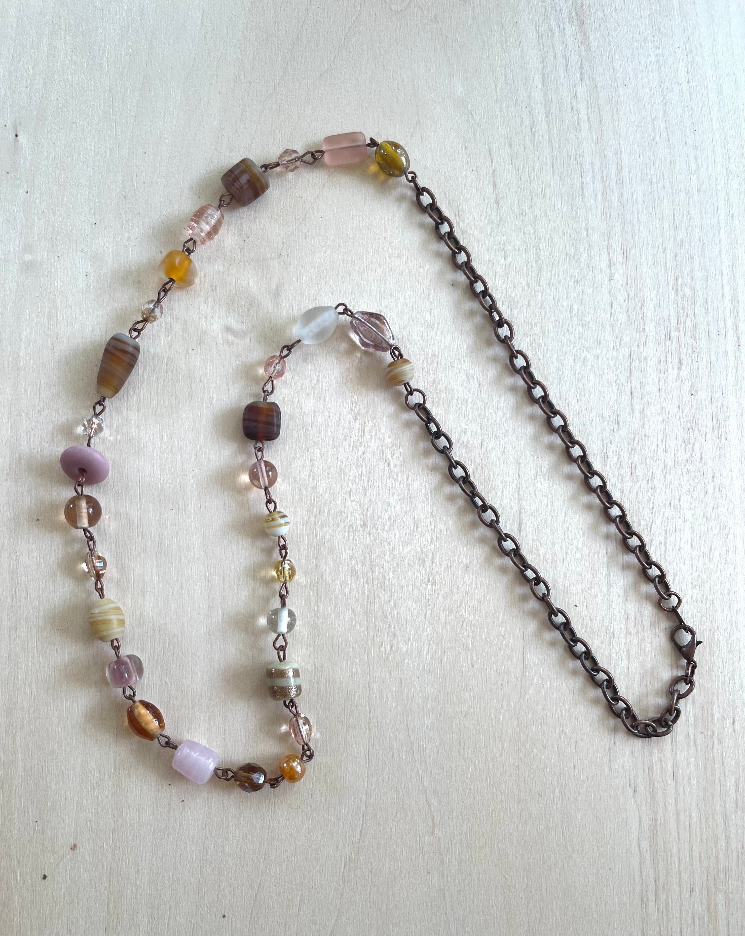 Handcrafted necklace with antique copper. Length is 28.25 inches. Glass beads.