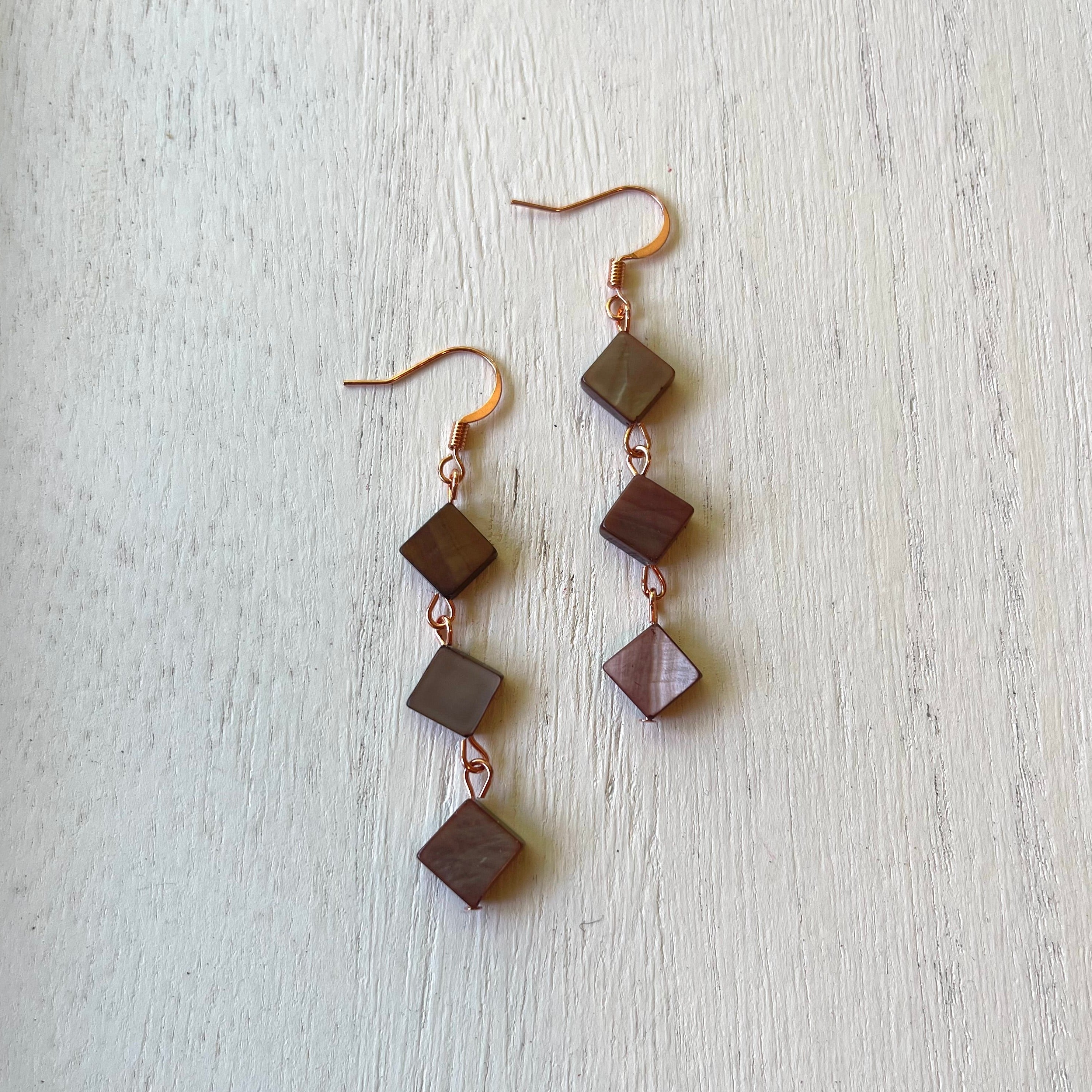 Handcrafted earrings on copper earring wires and components. Bourbon colored mother of pearl beads.