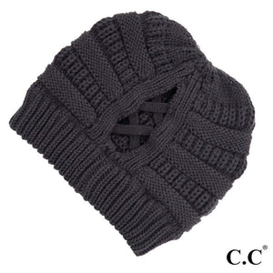 Ribbed Knit Beanie Featuring Criss-Cross Ponytail Detail. Multiple Ways to Wear. One size fits most. 100% Acrylic. Care: Hand Wash, Cold; Do Not Tumble Dry; Do Not Iron; Do Not Bleach; Dry Clean, Any Solvent Except Trichloroethylene.