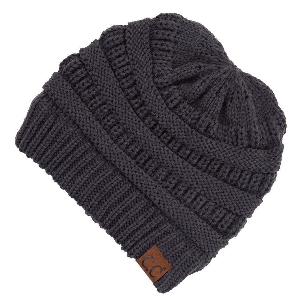 Ribbed Knit Beanie Featuring Criss-Cross Ponytail Detail. Multiple Ways to Wear. One size fits most. 100% Acrylic. Care: Hand Wash, Cold; Do Not Tumble Dry; Do Not Iron; Do Not Bleach; Dry Clean, Any Solvent Except Trichloroethylene.