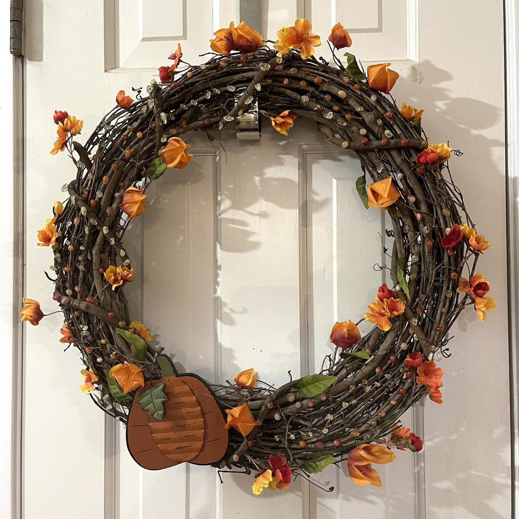 Handcrafted fall gemstone wreath on a 18in. grapevine wreath base. Carnelian and citrine gemstones wire wrapped on wreath.  Florals and a metal and wooden pumpkin accent.