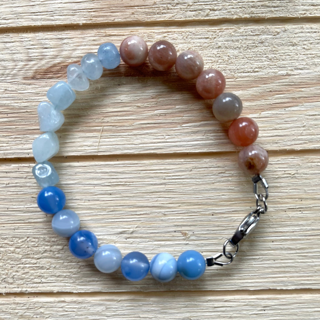 Handcrafted 8 inch bracelet. Length: 8 inches. Stainless steel clasp, components. Aquamarine, agate, and sunstone. 