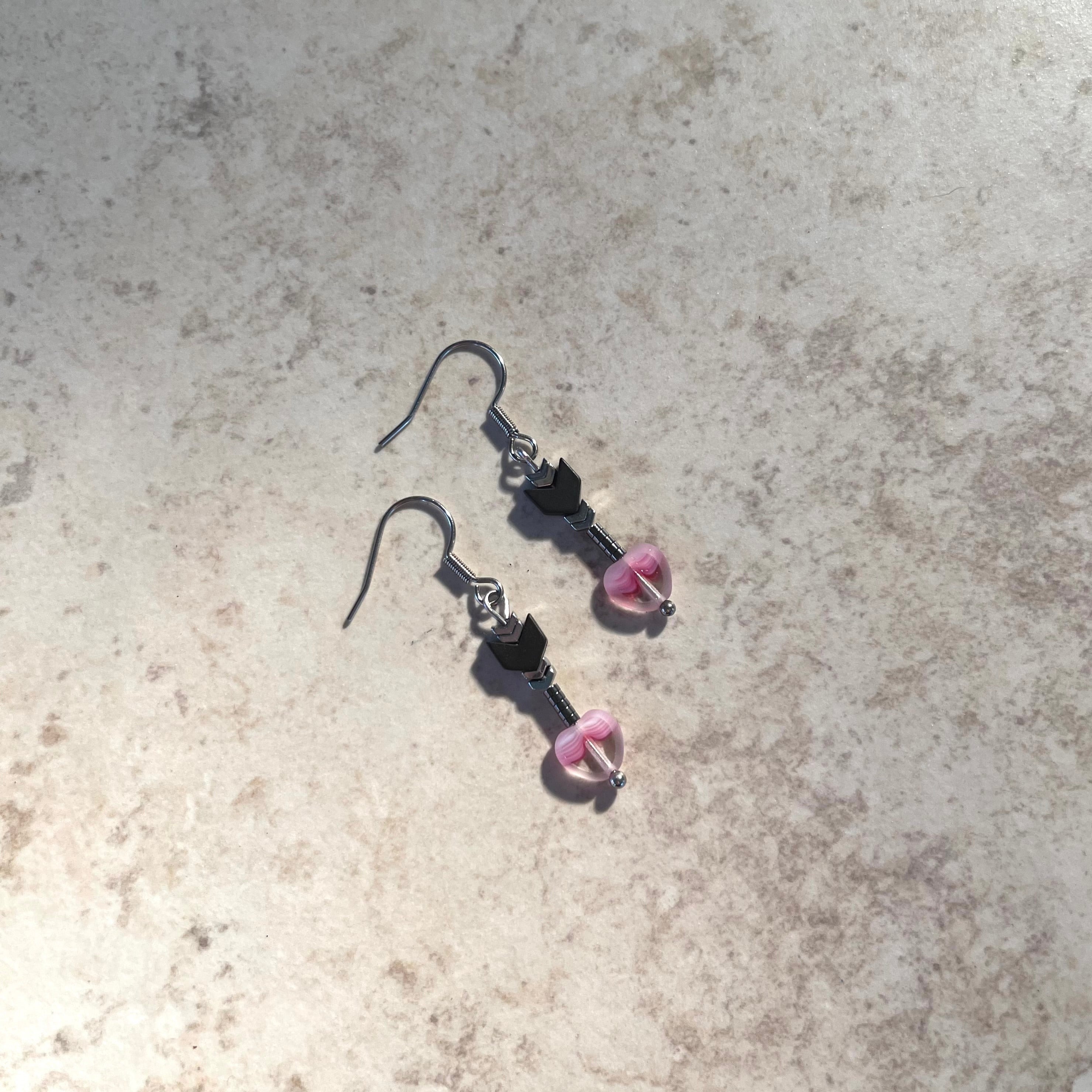 Handcrafted on stainless steel earring wires. Hematite stones and glass heart beads.