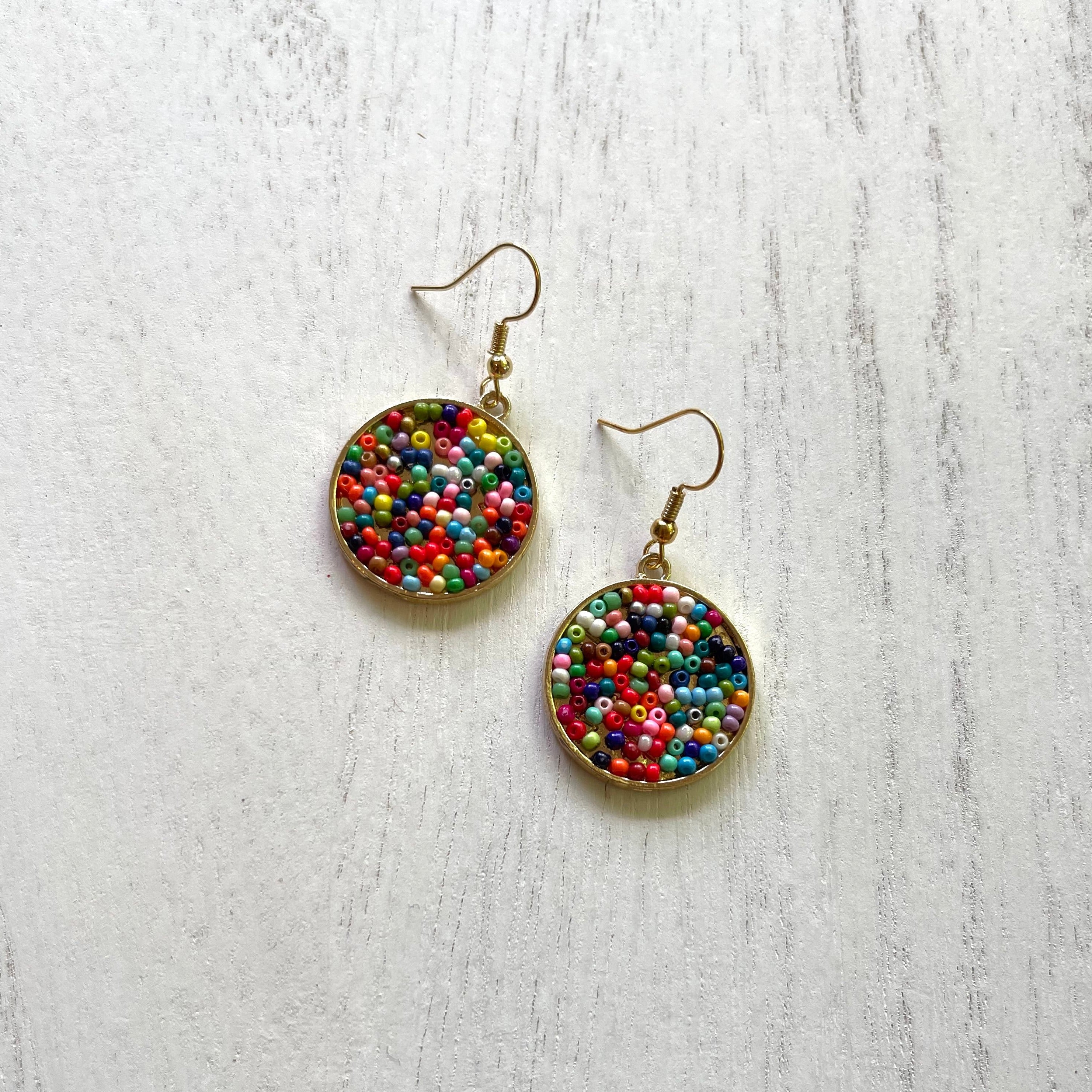 Handcrafted earrings on 18K gold plated earring wires. Seed bead pendants. 