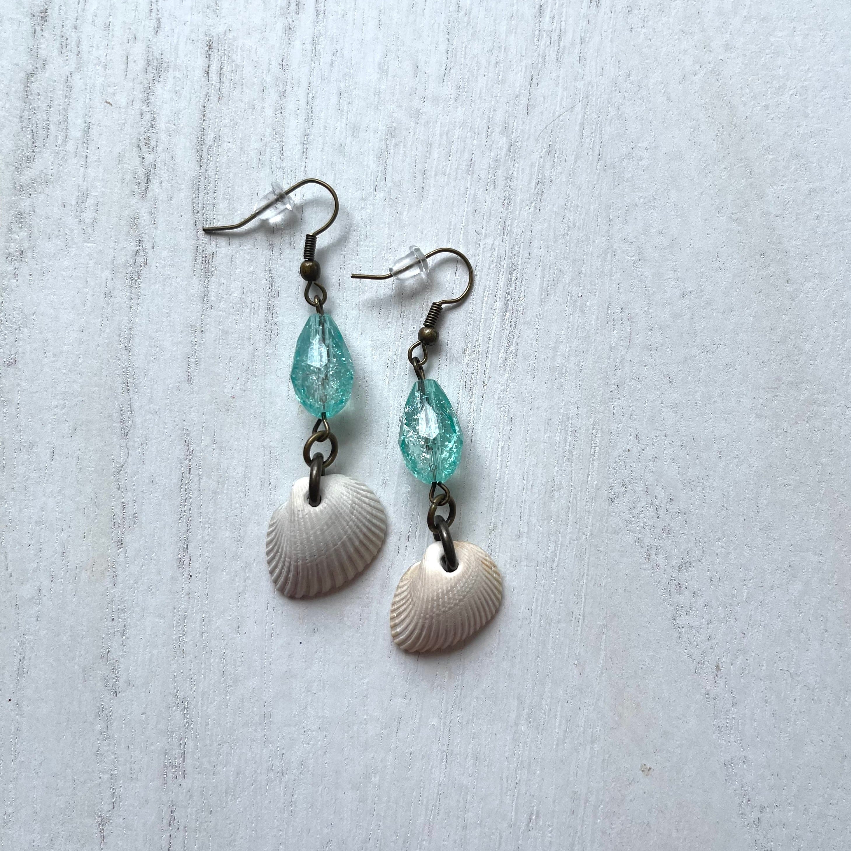 Handcrafted earrings with all brass earring wires and components. Shells found on the Galveston beach and glass beads.