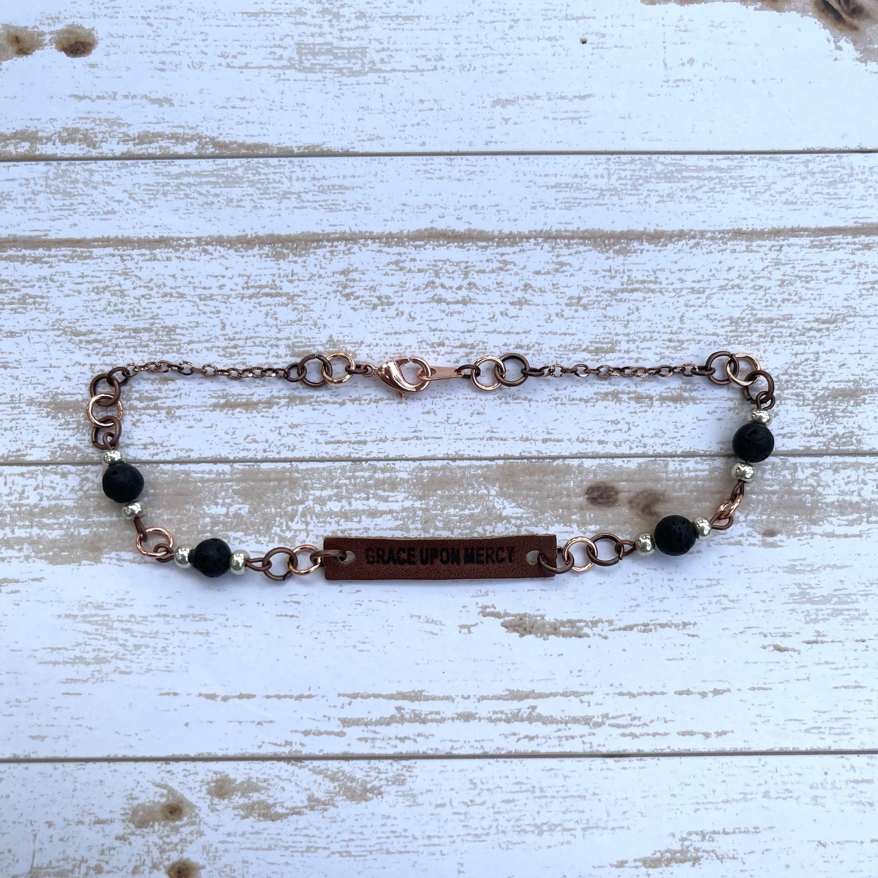 Handcrafted with copper components. Leather, Czech glass beads, and lavastone. Length is 10 1/2 inches.