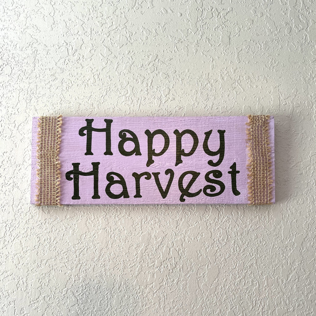 Sign is hand painted lavender and ivy green. Sign is wrapped in burlap ribbon and has a bracket to hang on wall.  Sign measurements are approximately 15x5 1/2 inches.