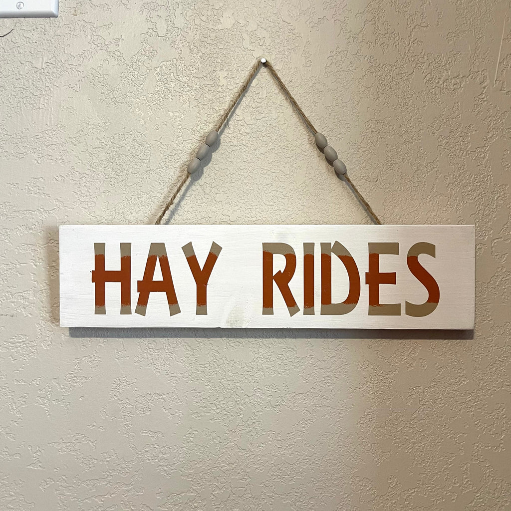 Handcrafted wooden sign with jute rope for hanging. Length is 14 inches. Painted and sealed.