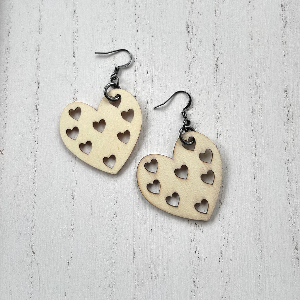 Wooden heart cutouts.  Gunmetal plated earring wires. 