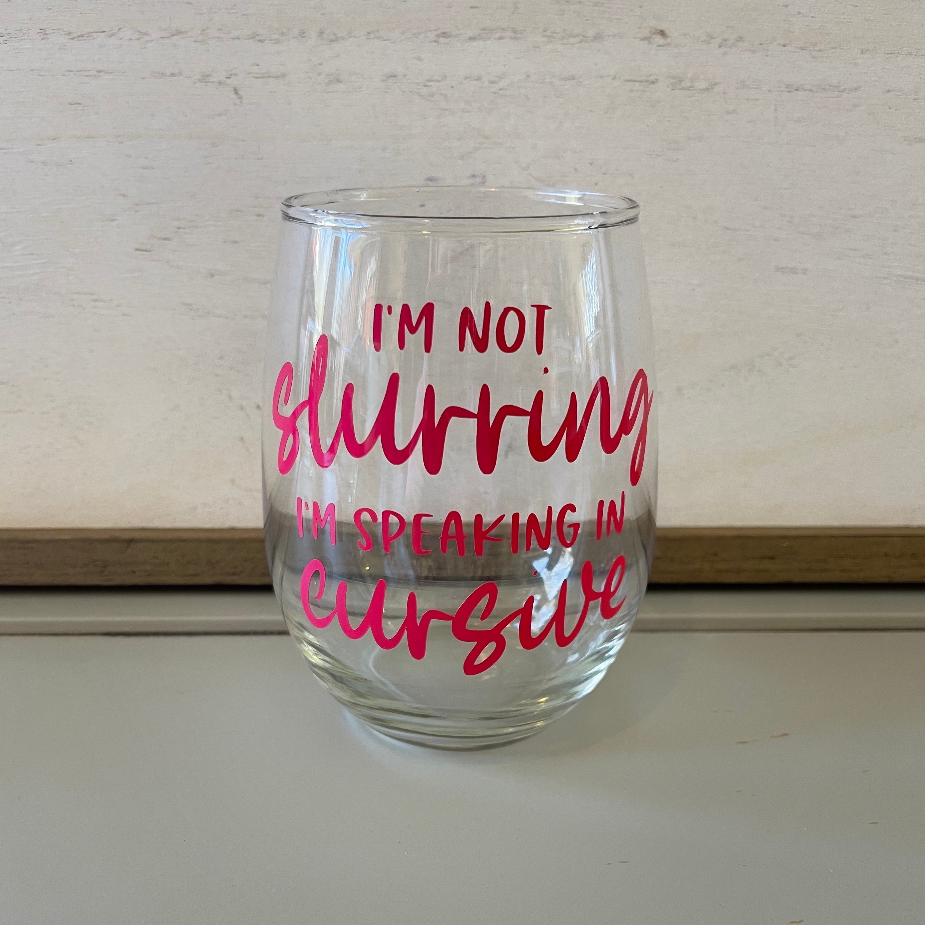 Glass stemless wine glass adorned with witty saying in permanent vinyl.  Holds 20 ounces of liquid. Care instructions: Hand wash only, not dishwasher safe, do not microwave, do not soak.