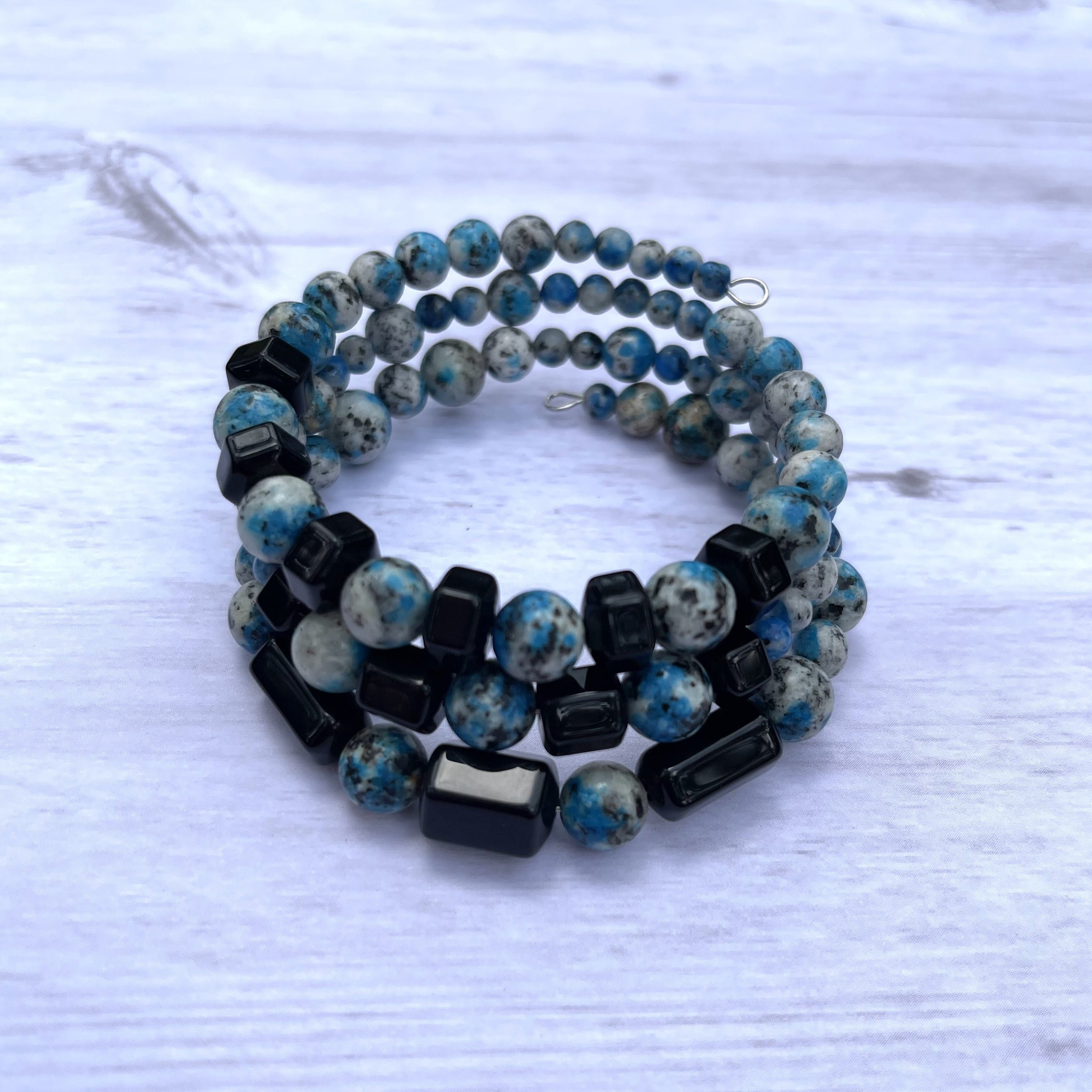 Handcrafted wrap bracelet on stainless steel memory wire. Simulated K2 stone which is a combination of granite and azurite, and black special onyx.