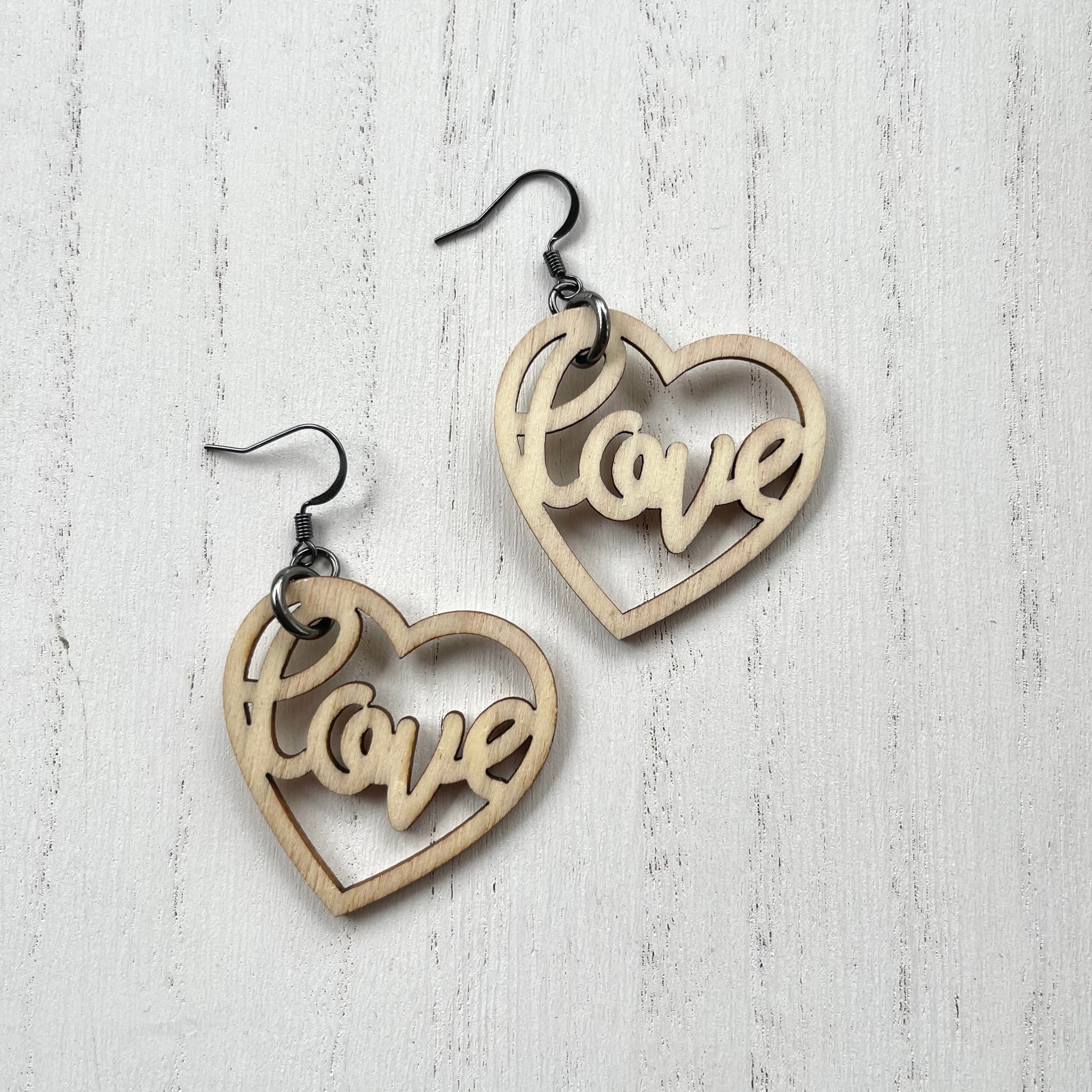 Wooden heart cutouts.  Gunmetal plated earring wires. 