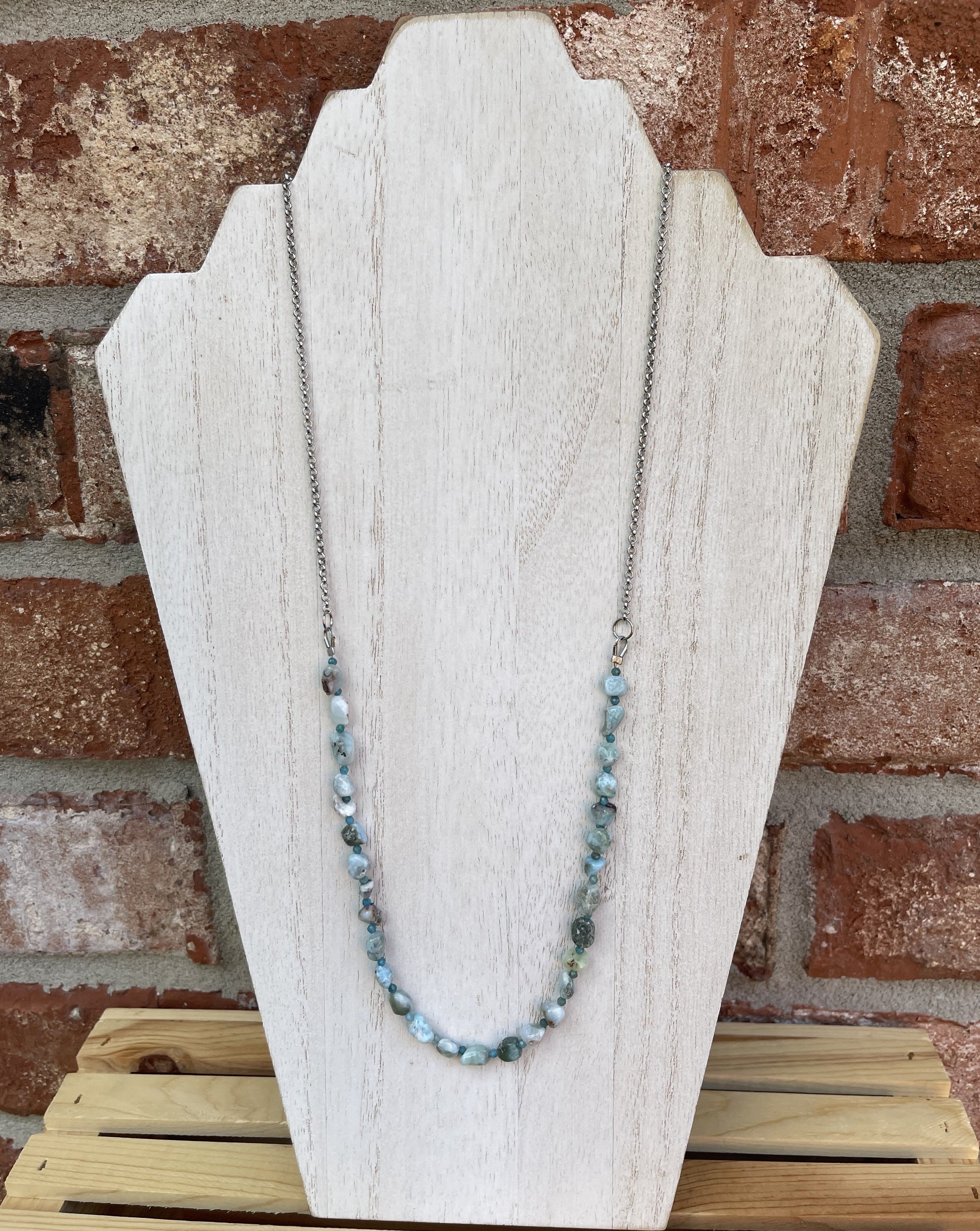 Handcrafted necklace on stainless steel chain and components. Necklace length is 25.5 inches in length. Larimar and apatite gemstones.