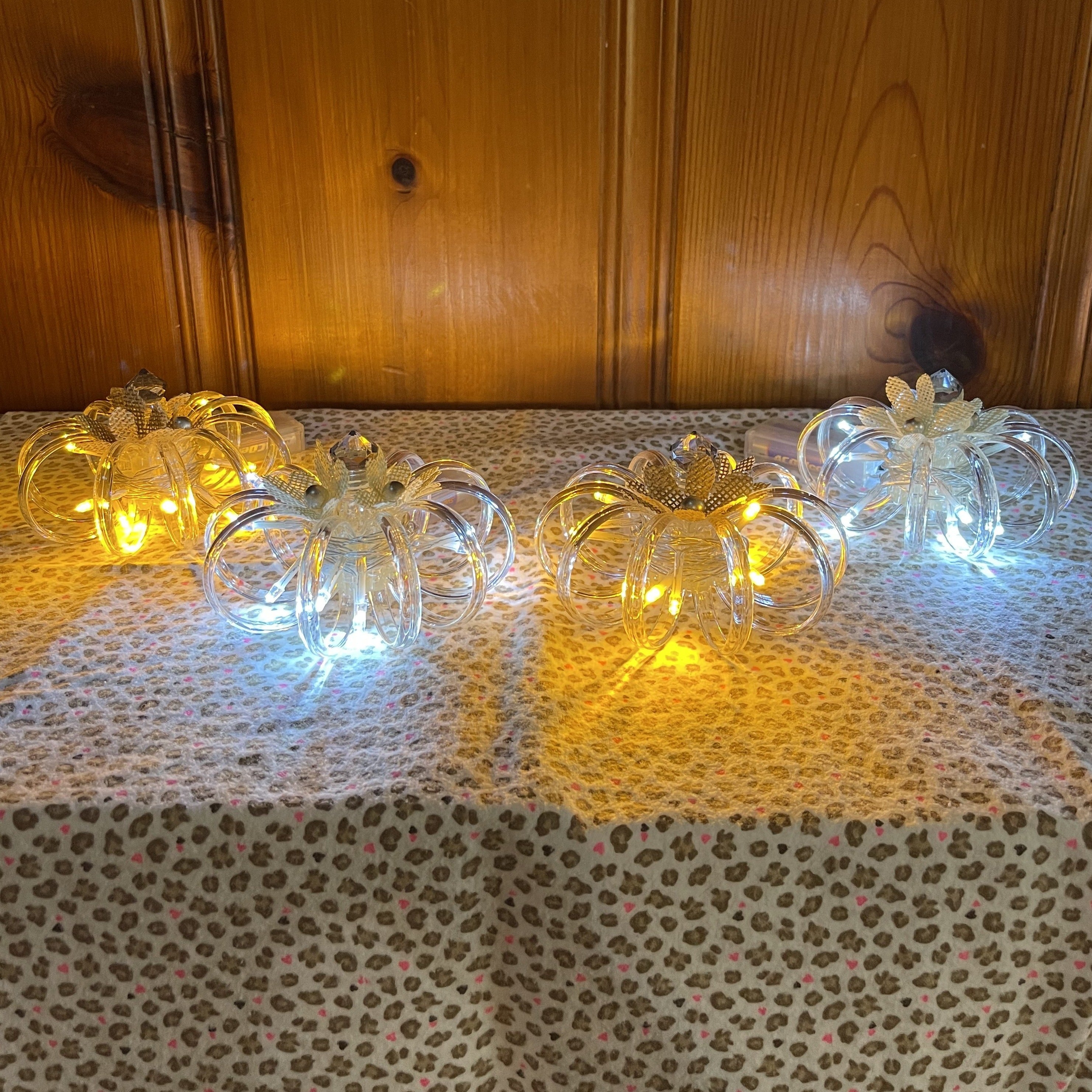 Handcrafted light up pumpkins. Made from plastic, glass, and burlap. Comes with LED light strand and 2 AA batteries included. Available in two colors.  Sold individually. 