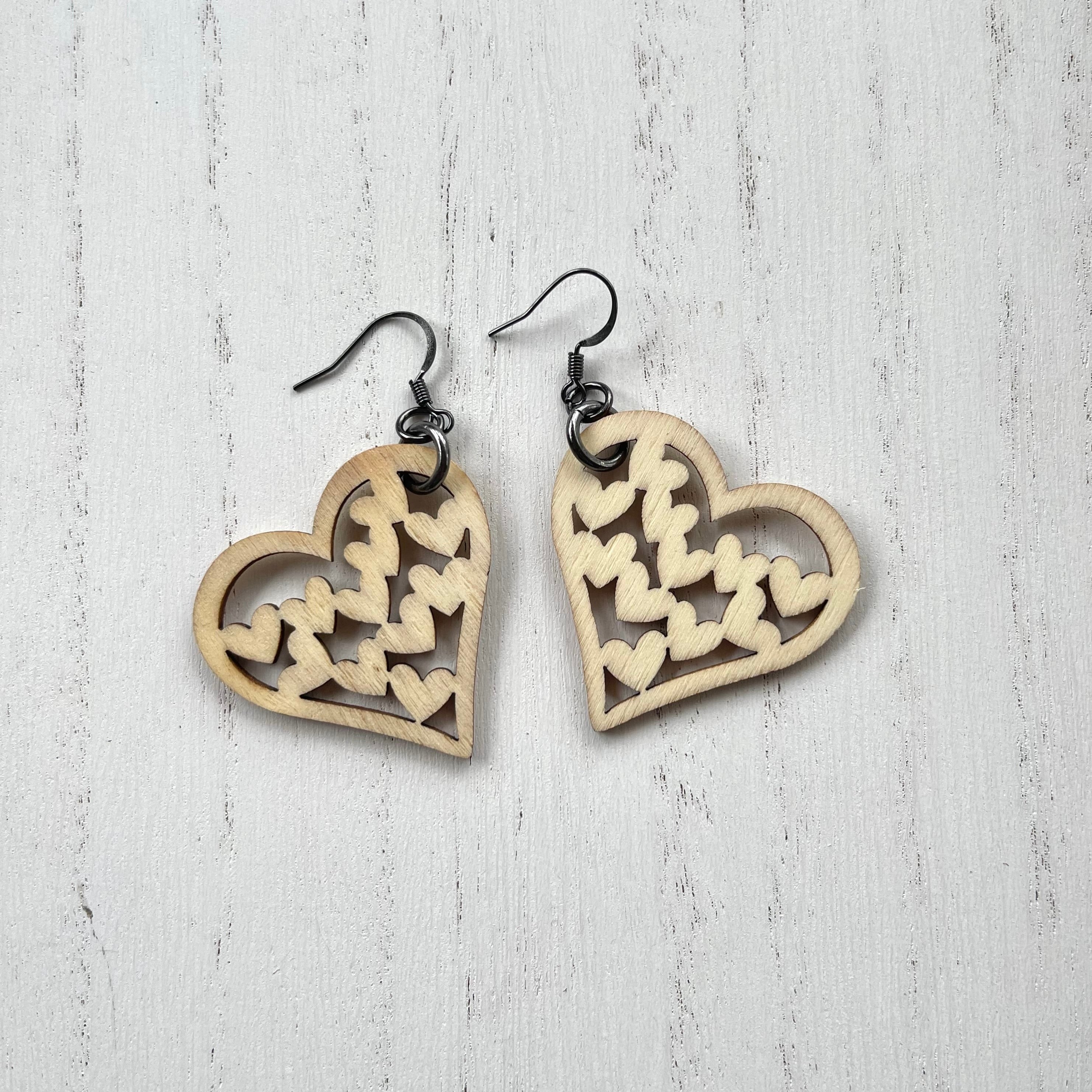 Wooden heart cutouts.  Gunmetal plated earring wires. 