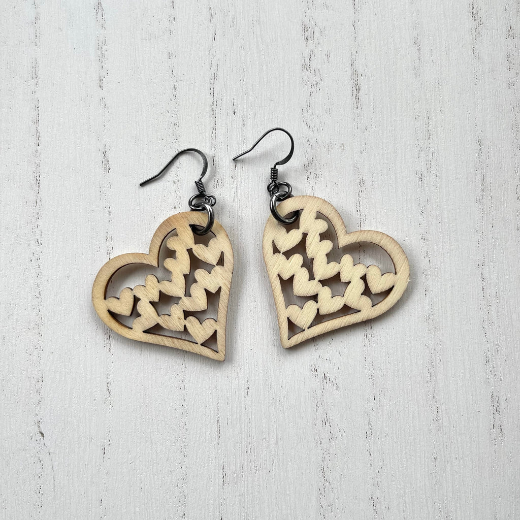 Wooden heart cutouts.  Gunmetal plated earring wires. 