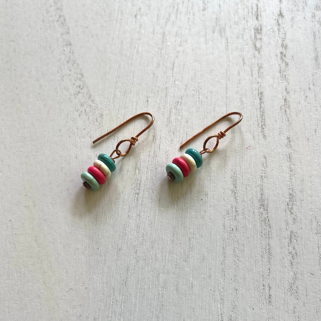 Handcrafted earrings designed with copper wires, components, and spacer accent beads. Beaded with dyed howlite. 