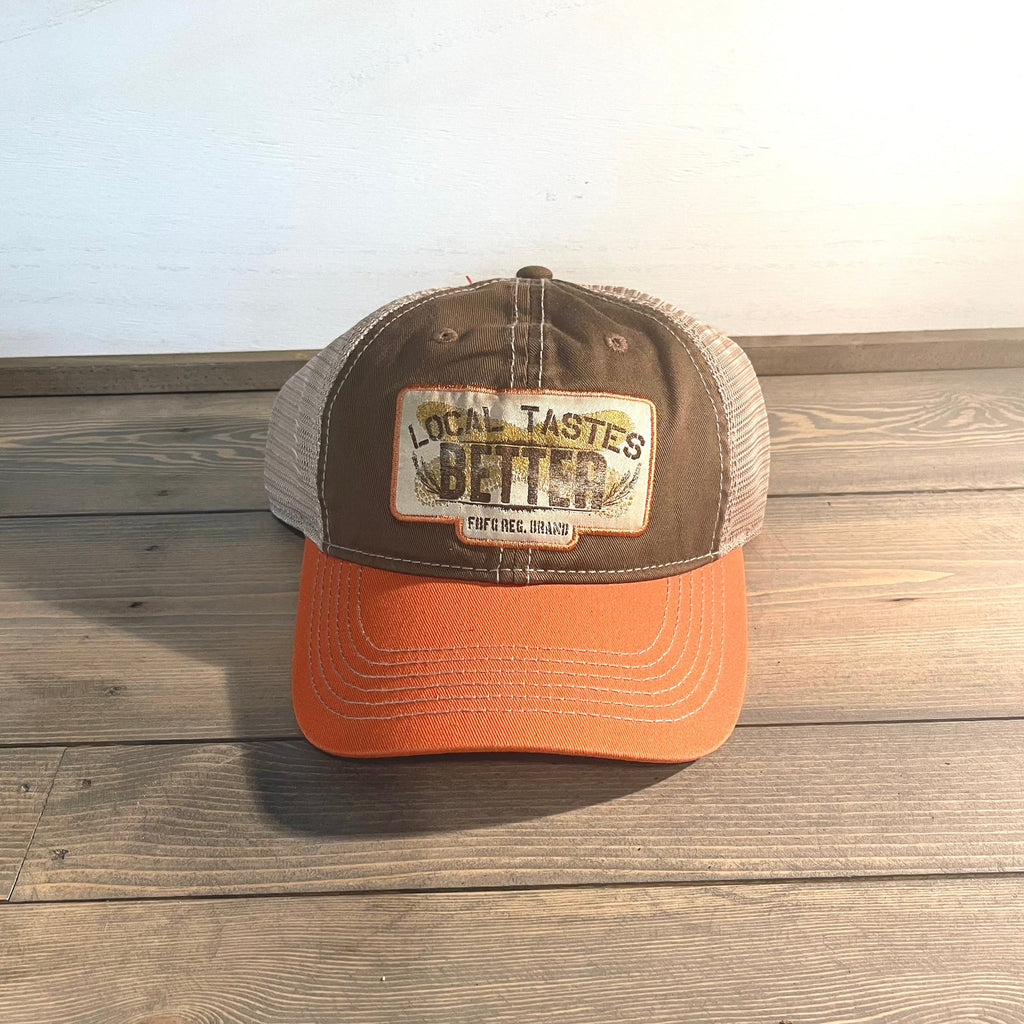 Men's Farm Boy local taste better cap. One size fits most. Mesh back. Adjustable snapback closure. Orange, brown, and tan.