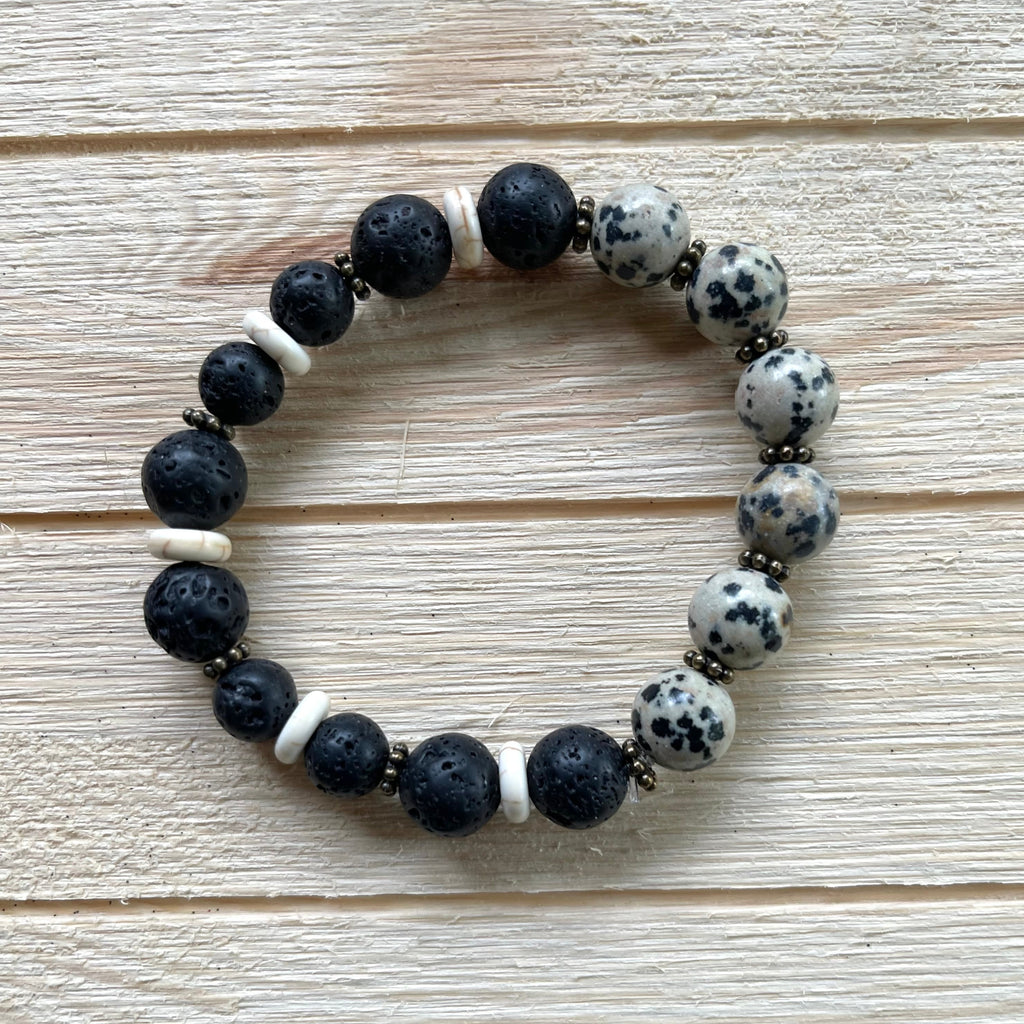 Handcrafted stretch bracelet on professional Ninja Stretch Cord. Beaded with lava stone, dalmatian jasper, howlite, and brass.