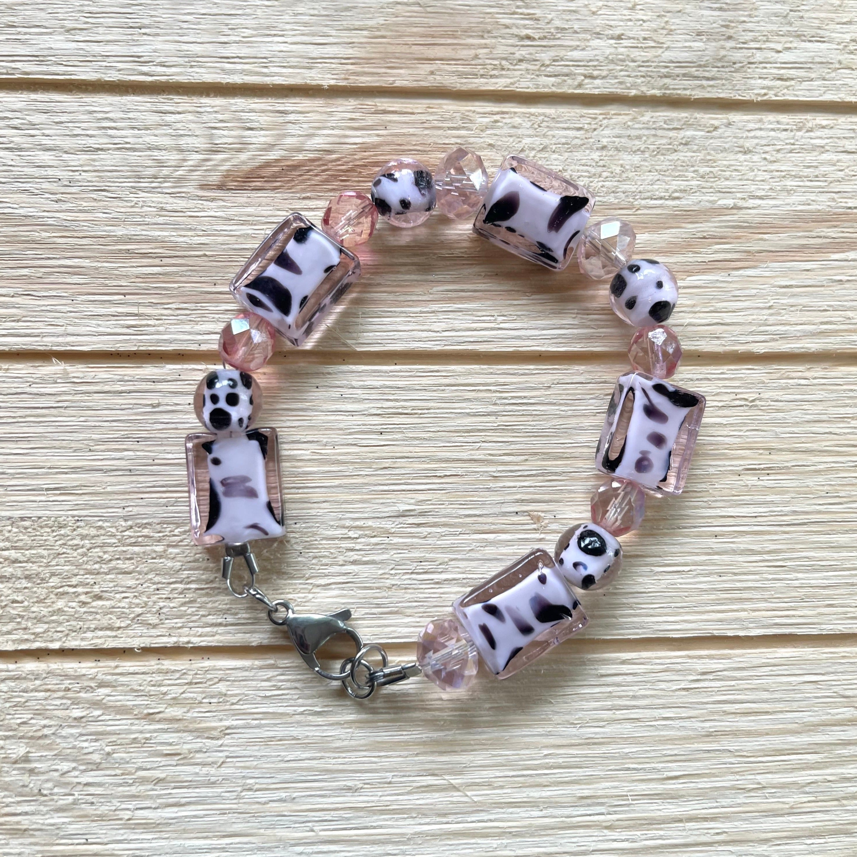 Handcrafted with glass cow-print beads and faceted glass beads in pink. Large 15mm stainless steel lobster clasp for easier clasping. Stainless steel components.  Bracelet is 8 inches long.